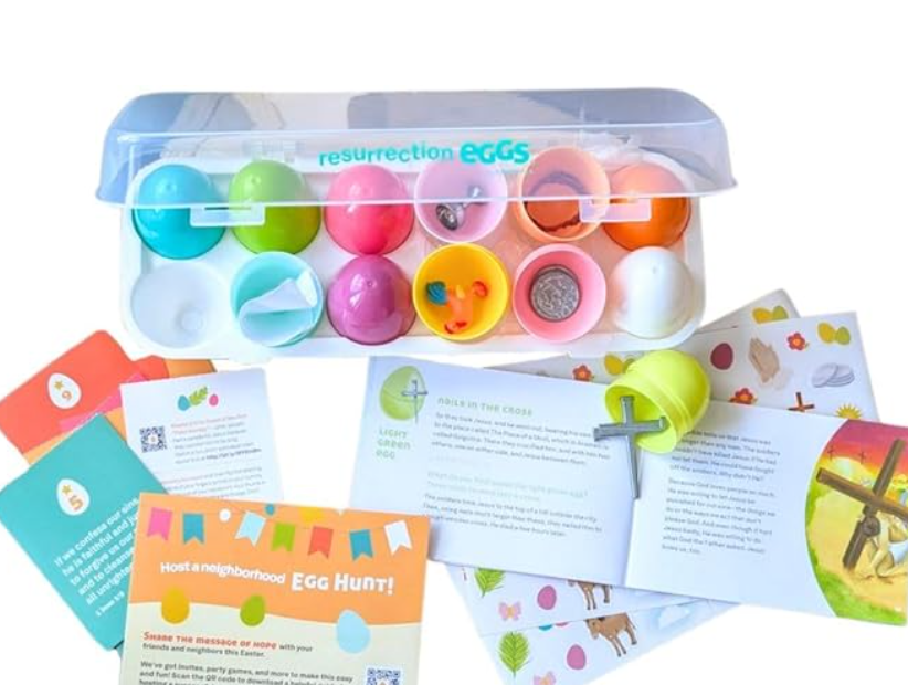 Colorful plastic Easter eggs, some open and some closed, come in a plastic container labeled 'resurrection eggs.' Surrounding items include informational cards, a small booklet, and an opened egg with small toys inside.