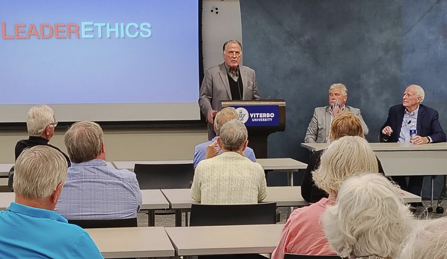 Lee Rasch addresses the audience at the Democracy Defense Project presentation in La Crosse.