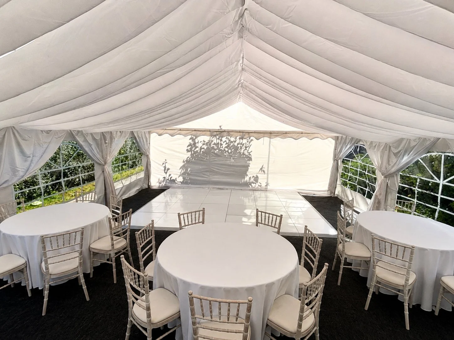 Beautiful marquee with white dance floor and tables