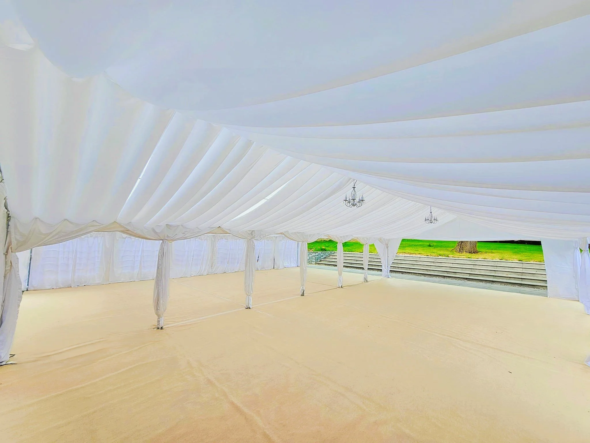 Luxury PVC wedding marquee with flooring and lining setup by NK Marquees – marquee hire Leicester and Northamptonshire