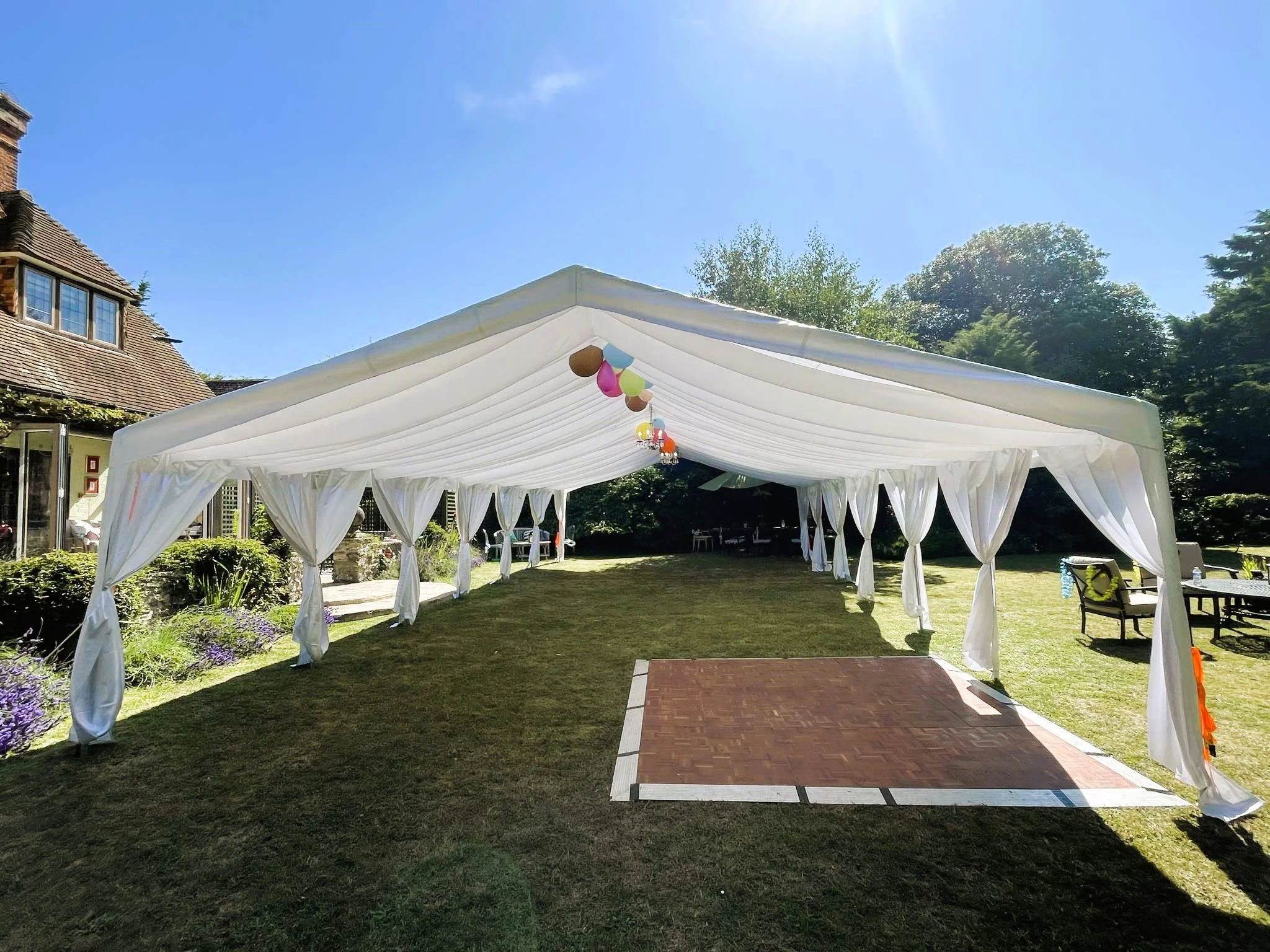 Luxury white wedding marquee with dance floor setup by NK Marquees in Northamptonshire