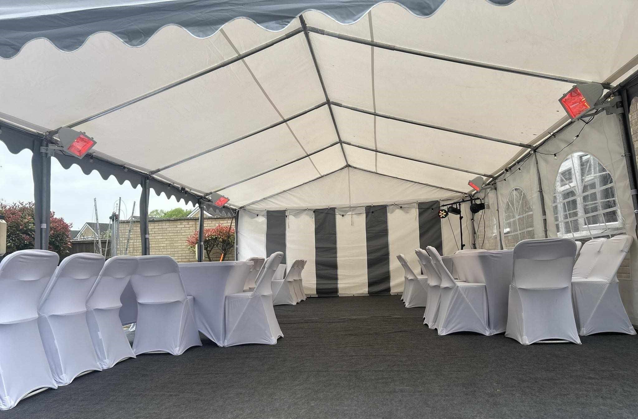 Marquee interior with tables, chairs and flooring setup for party or corporate event