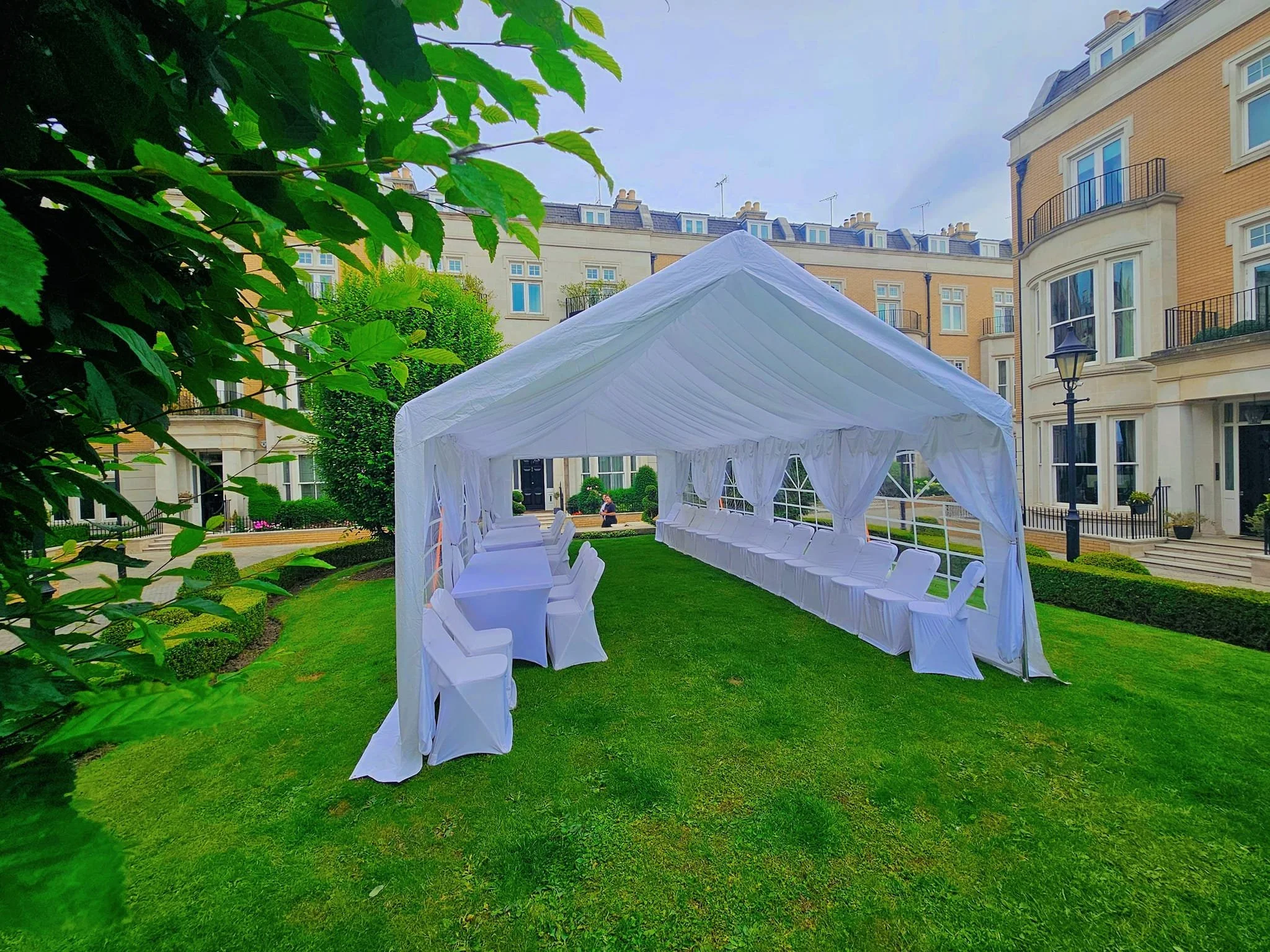 White garden marquee setup on grass for private event at residential venue