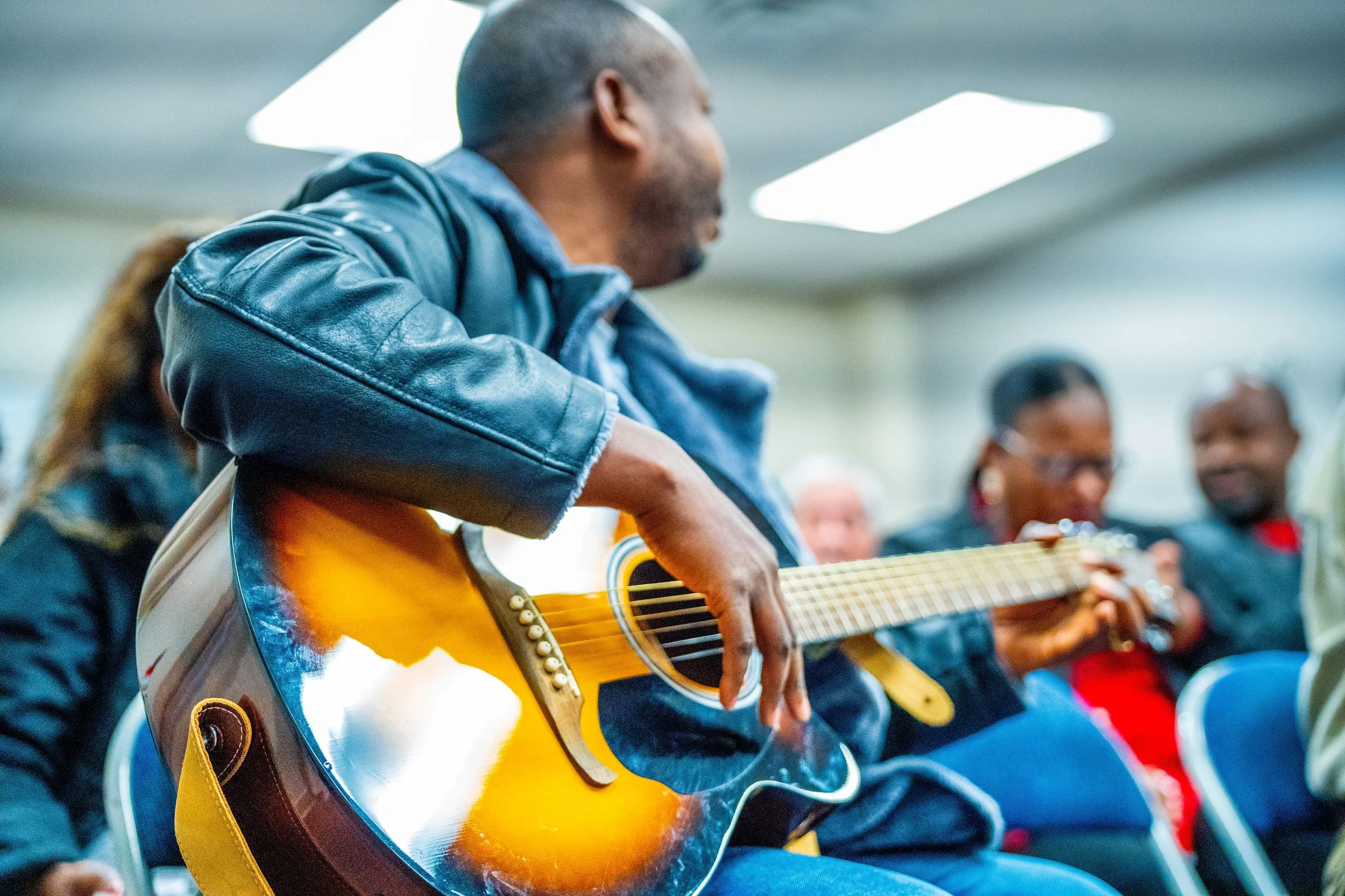 playing guitar in the international worship service at Westover Hills Church of Christ in Austin, TX