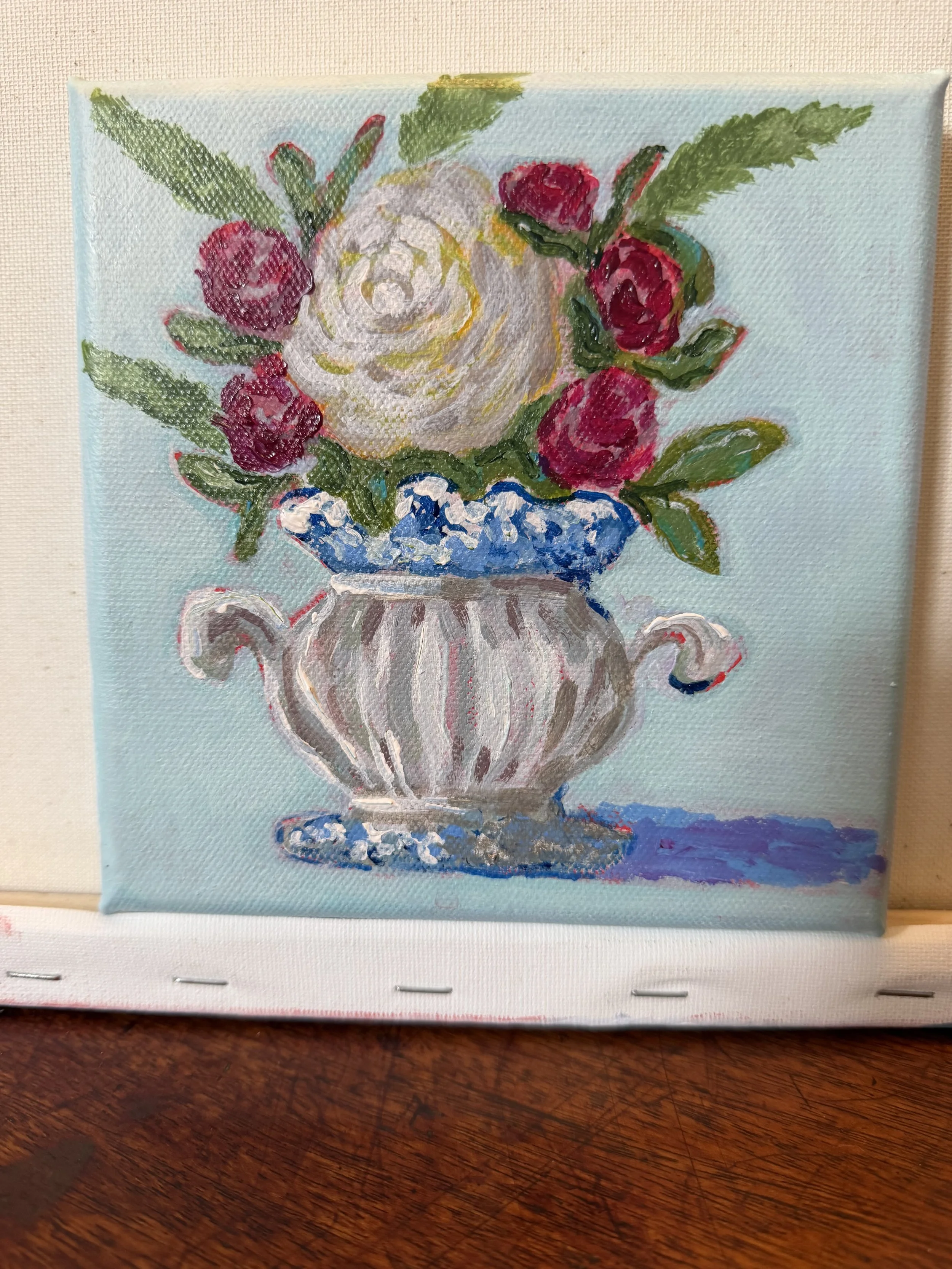 White rose, red minis in a pretty vase