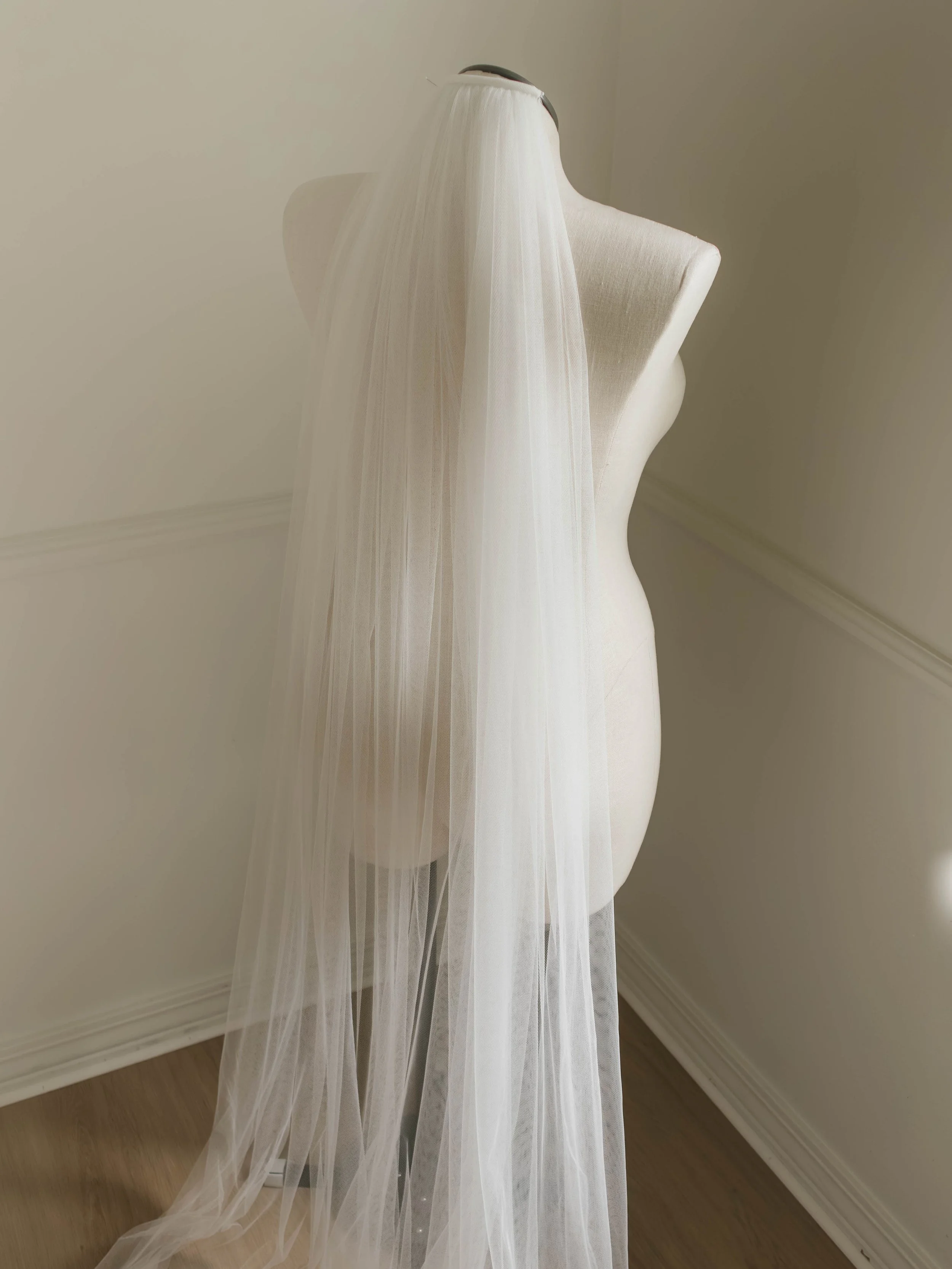 An ivory veil placed on the back of a clothesform