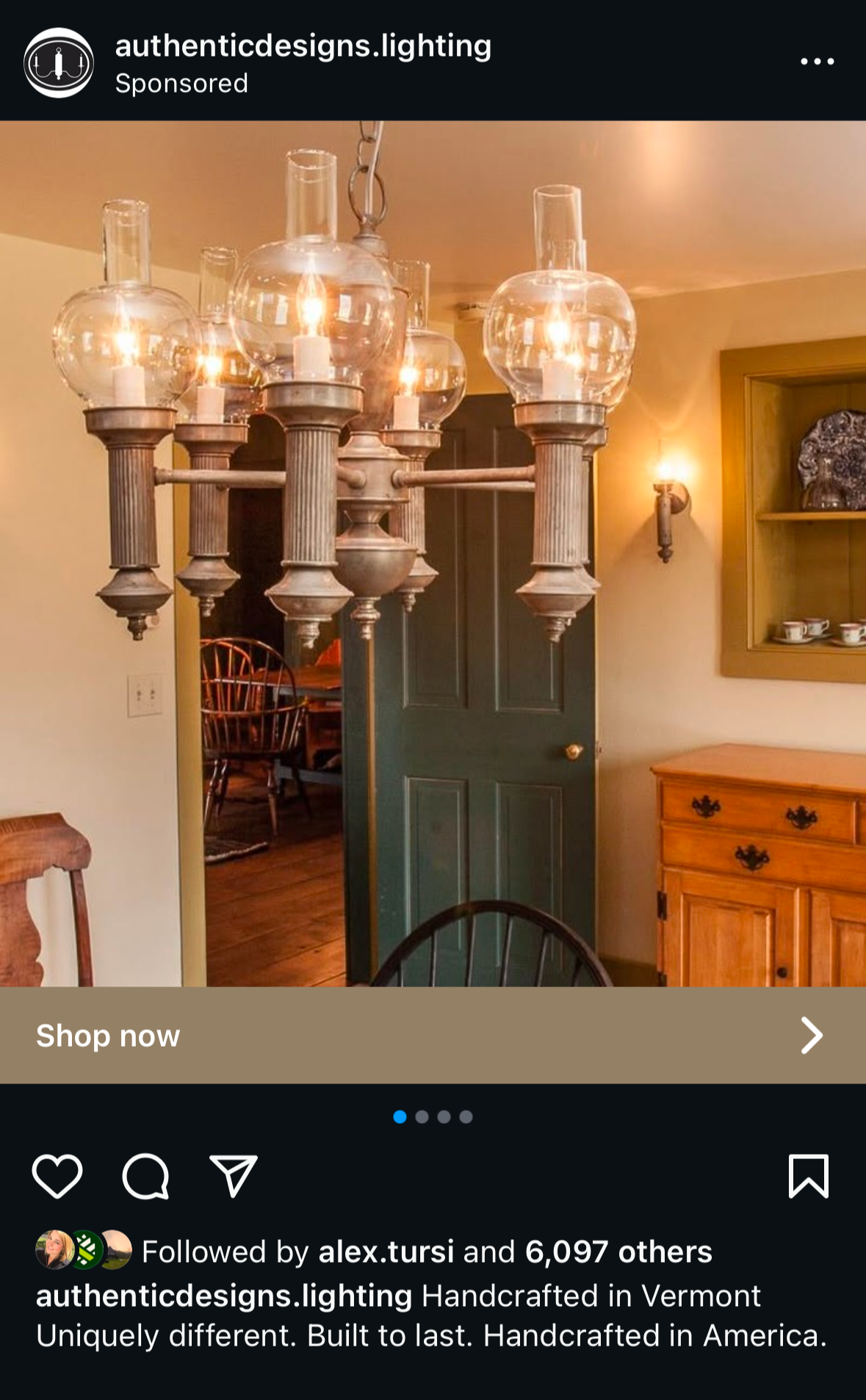 Vintage chandelier with multiple glass globes and candle-like bulbs hanging above a dining room.