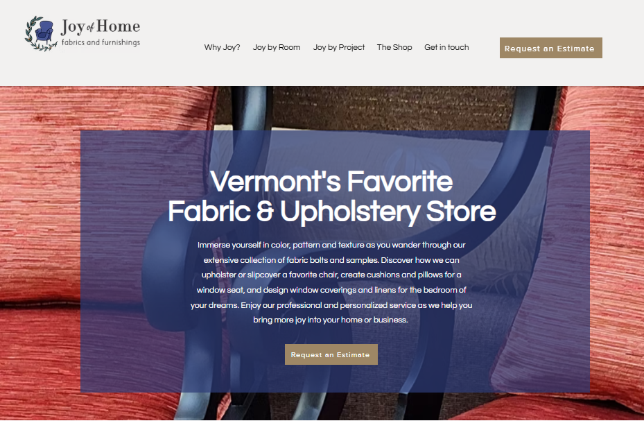 Screenshot of a website for Joy of Home fabrics and furnishings featuring a background of fabric samples and a large blue banner with white text promoting Vermont's favorite fabric and upholstery store.