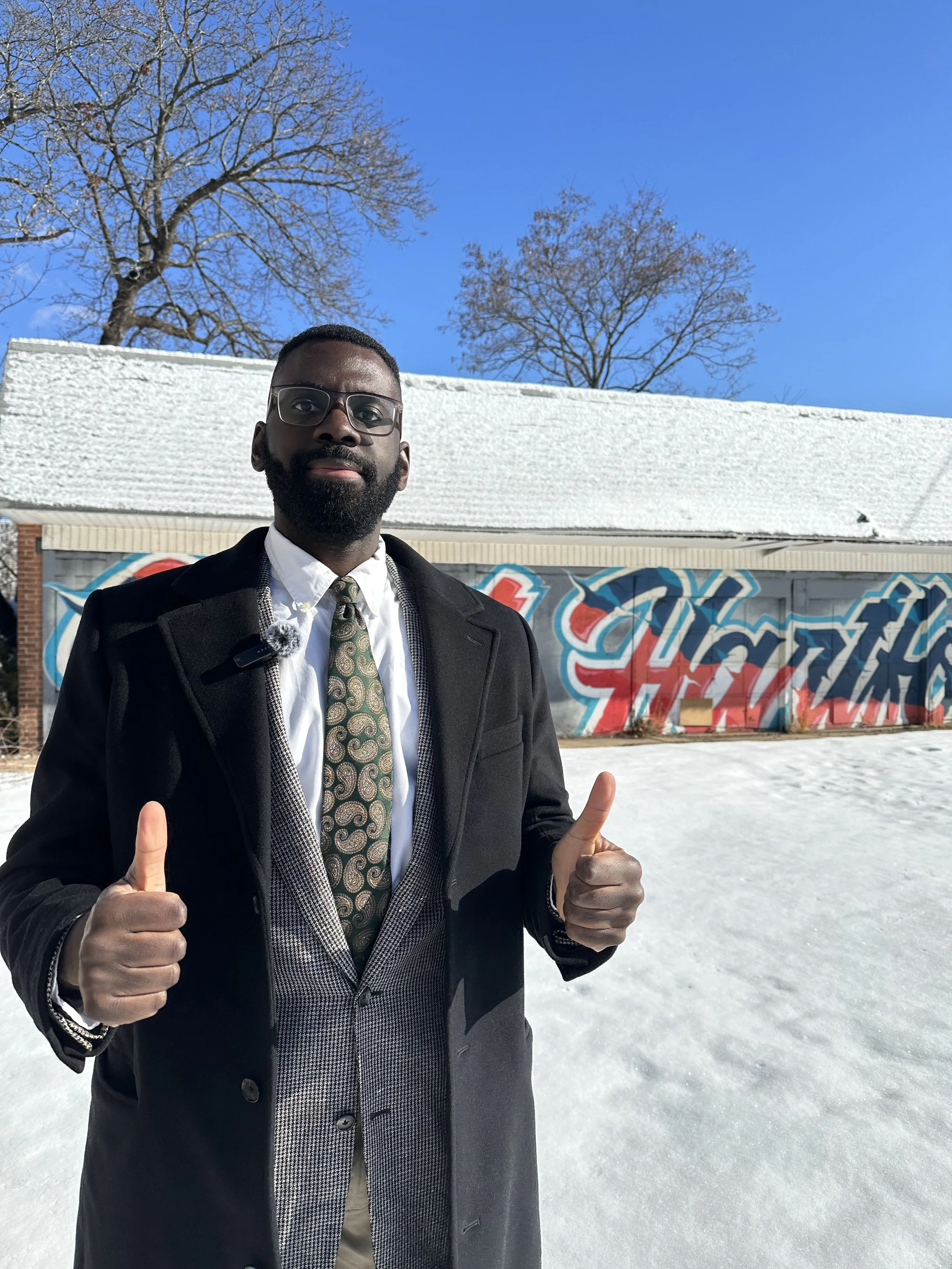 Olaleye in front of a snowy building in West Hartford.