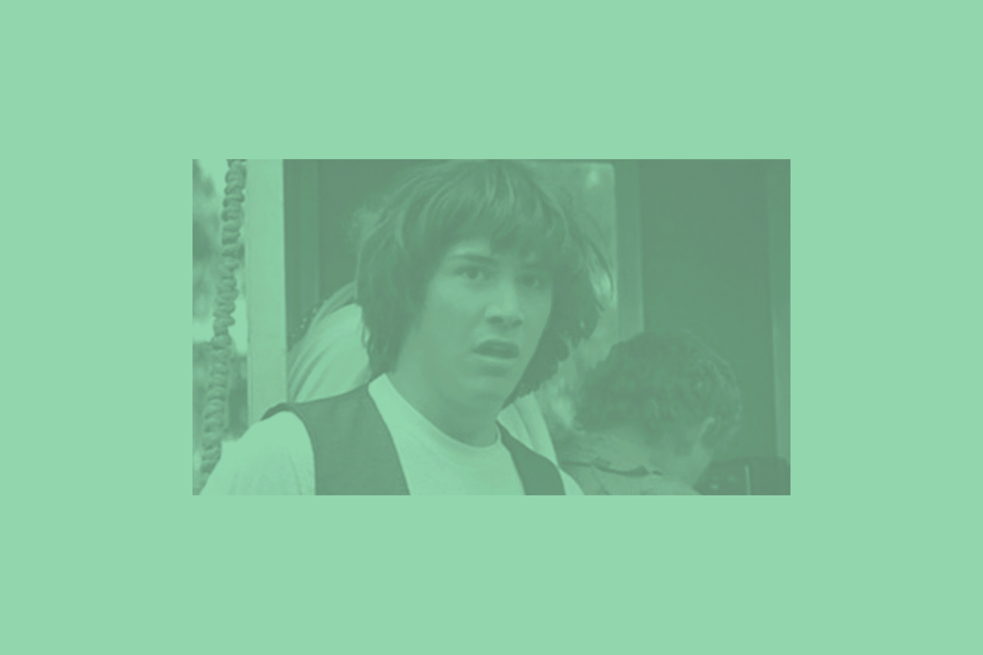 A woman with short, wavy hair and a surprised or confused expression on her face, wearing a white shirt and a vest.