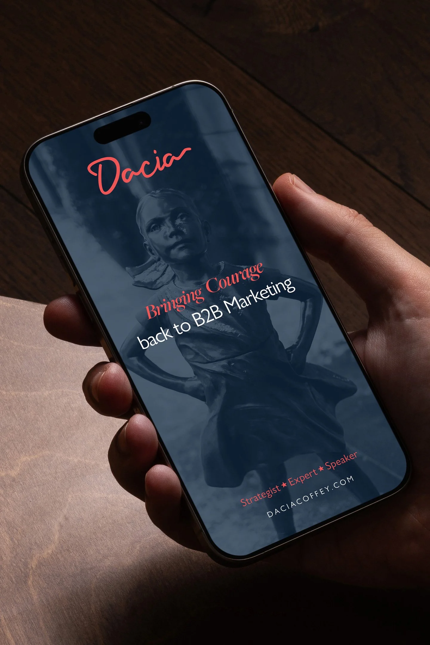 Smartphone displaying a presentation slide for Dacia, with the title 'Bringing Courage back to B2B Marketing' and a background photo of a woman in a vintage military uniform.