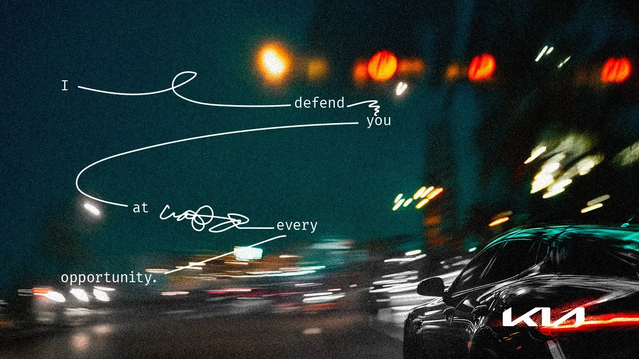 A dark, blurry city street scene at night with moving cars and bright streetlights. Overlaid text in a handwritten style reads, "I defend you at every opportunity."