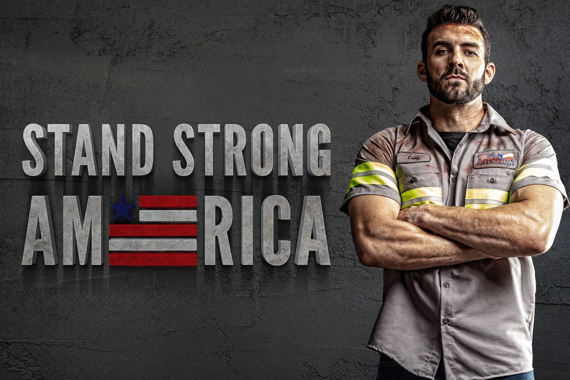 A man in work uniform with crossed arms standing in front of a wall with the text 'Stand Strong America' and an American flag graphic.