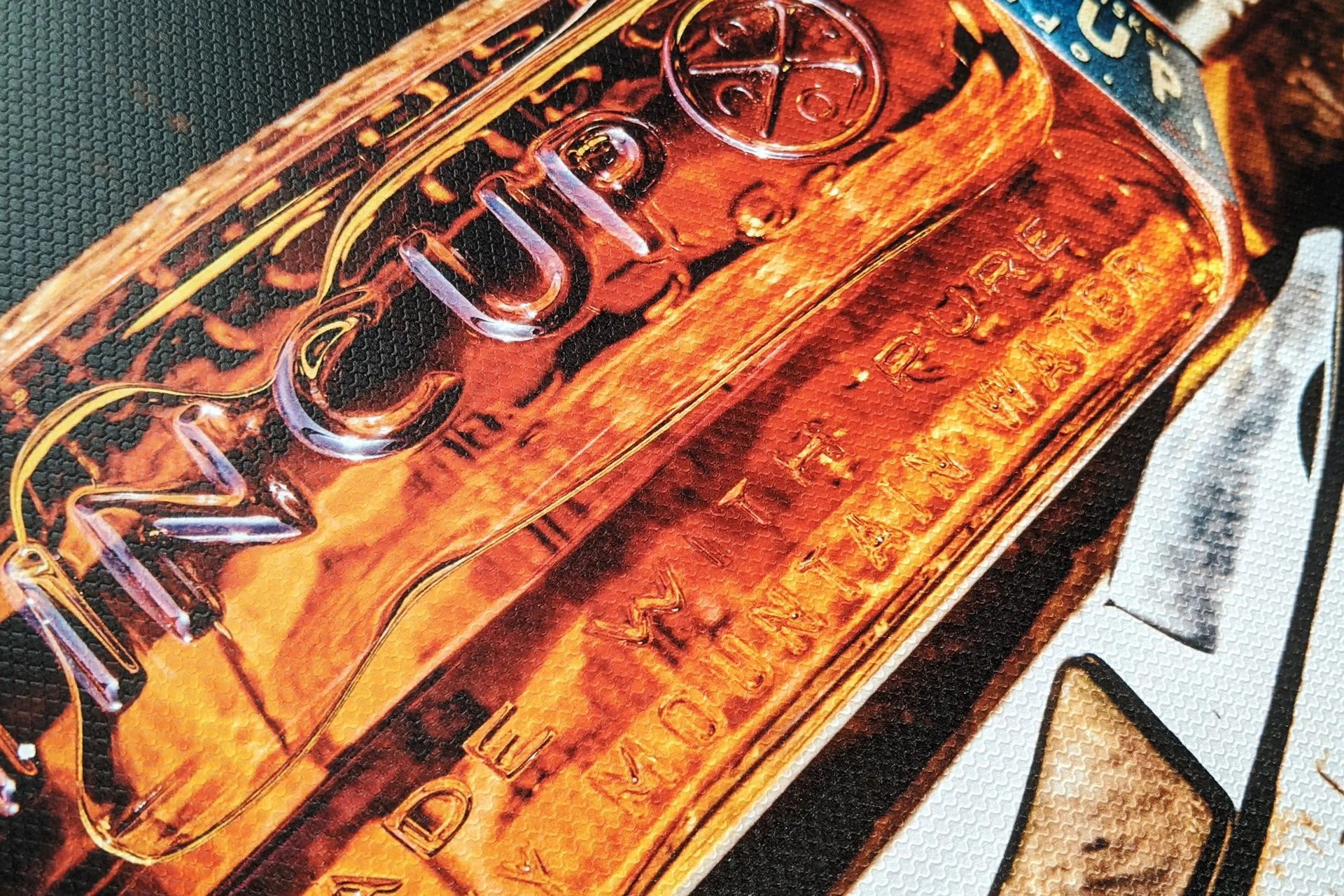 A close-up of a glass bottle of Jack Daniel's Old No. 7 Tennessee Whiskey with the label clearly visible, displaying the brand name and details, placed on a surface with a black and white geometric pattern.