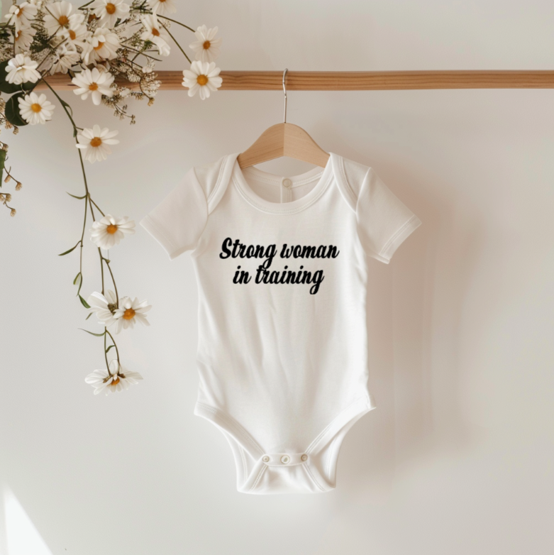 Strong woman in training baby bodysuit