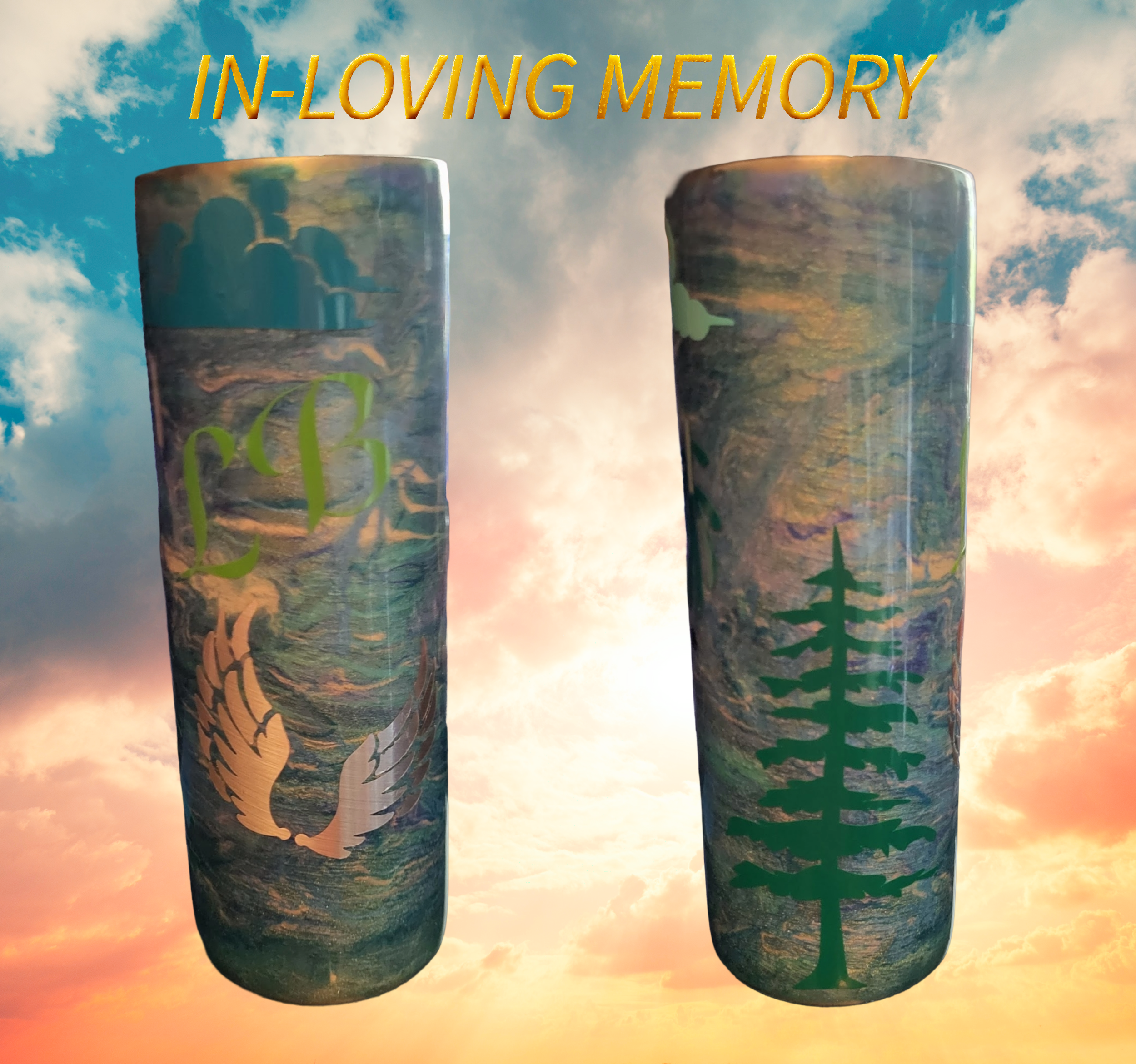 Two cylindrical memorial plaques with nature-themed designs, set against a sunset sky with clouds. The left plaque has a green tree and a bird silhouette, and the right plaque has a pine tree silhouette. Text at the top reads "In-Loving Memory" in ye