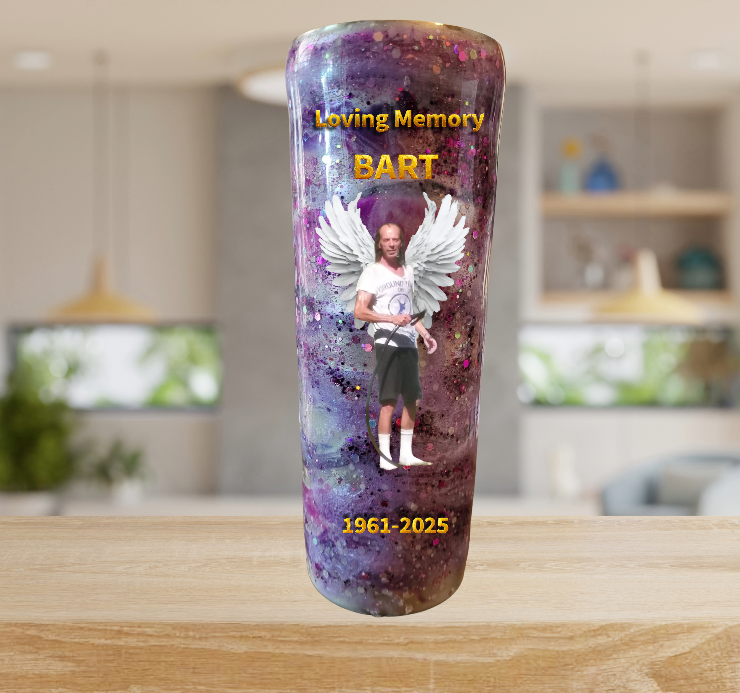 A memorial glass with a colorful, galaxy-like background, honoring BART with angel wings, a photo of him, and dates 1961-2025.