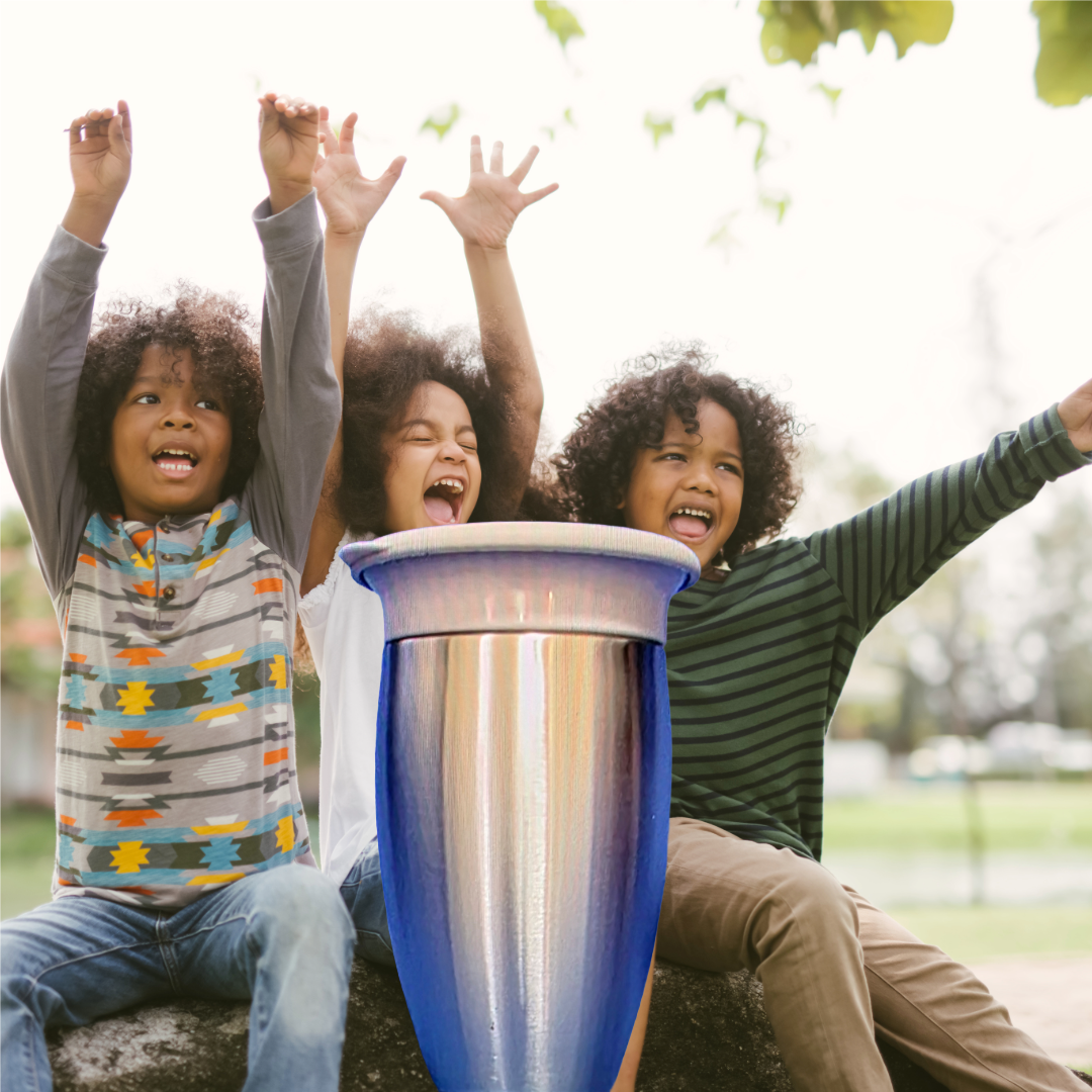 Three children with curly hair celebrating outdoors with arms raised behind a colorful ceramic pot.