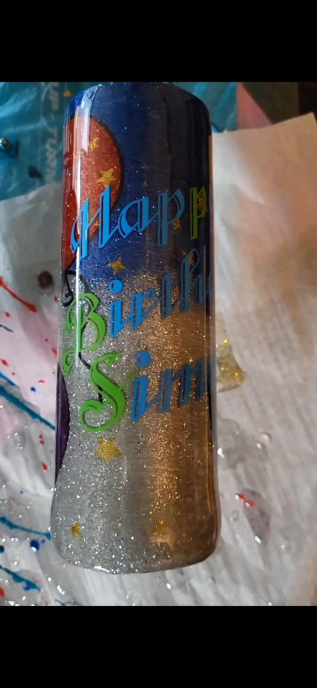 A birthday cake with colorful decorations and a message that reads 'Happy Birthday Sisi' written in multicolored letters.