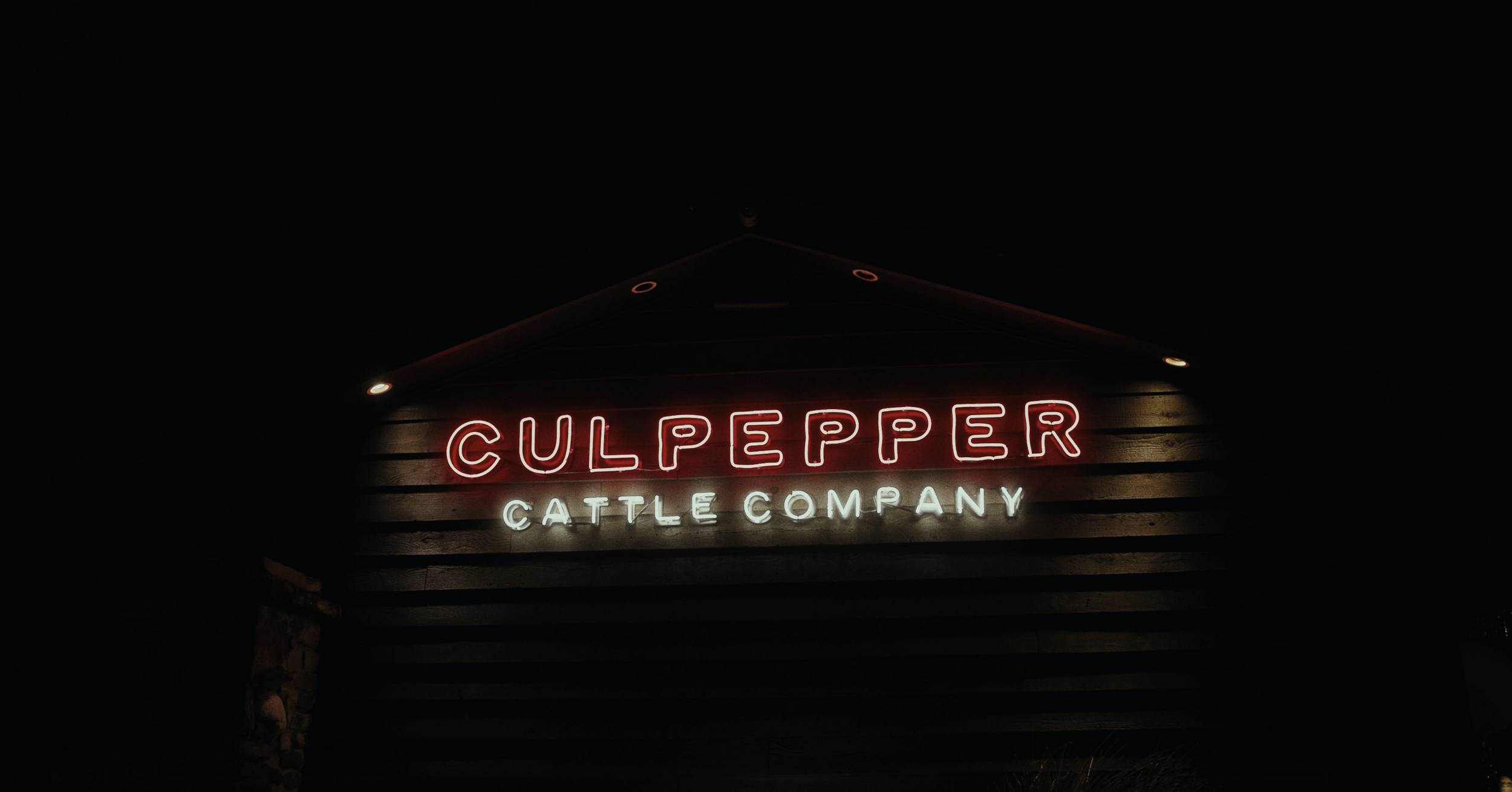 Neon sign with the text 'Culppepper Cattle Company' on a dark background