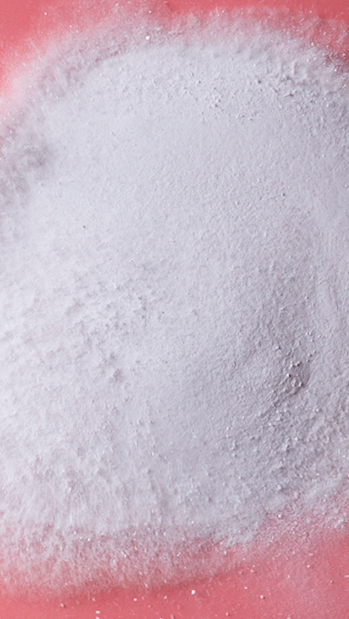 White powder spread over a pink surface.