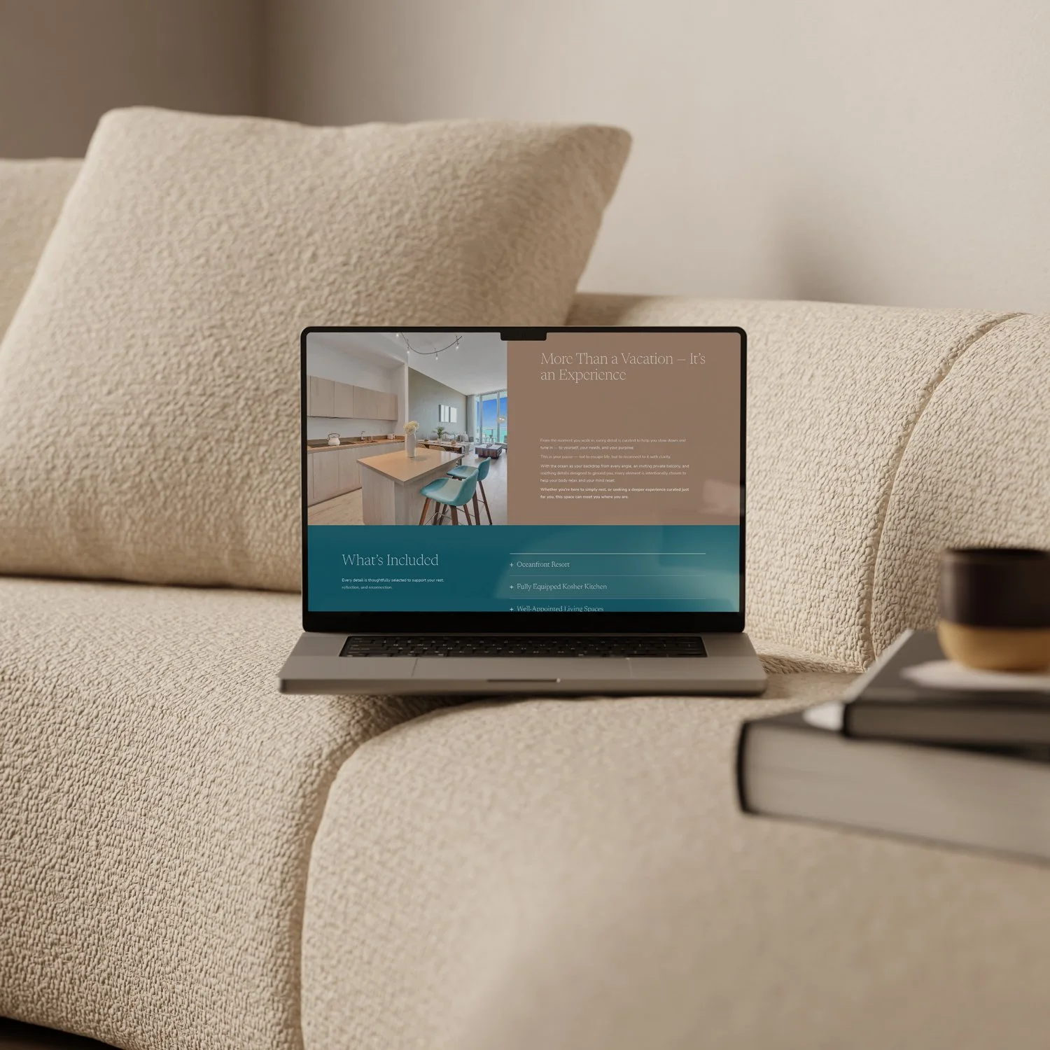 Laptop on a textured beige sofa displaying a webpage about vacation experiences, with a small black bowl and stack of books nearby.