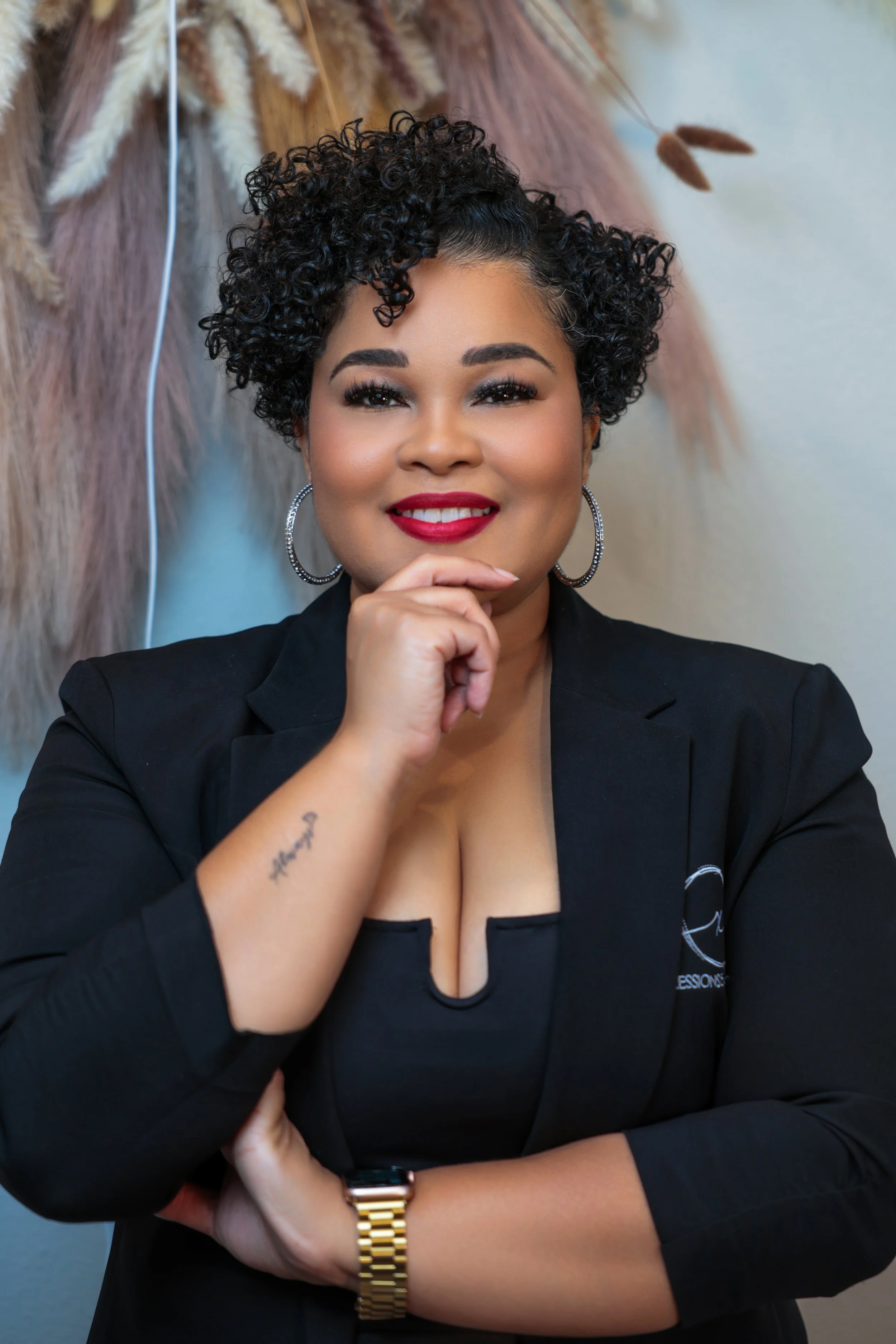 Person holding a tall, ceramic, two-tone vase with a narrow neck and textured surface.