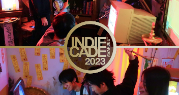 Photo of the Indiecade 2023 event with people gathered around gaming stations and screens in a decorated indoor setting.