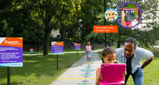 Two children and an adult walking on a park trail with colorful markings. The children are holding a pink tablet, and there are informational signs about a gigatic number line. A small inset shows a child's hand using a tablet with the caption 'Let's walk on the number line!'
