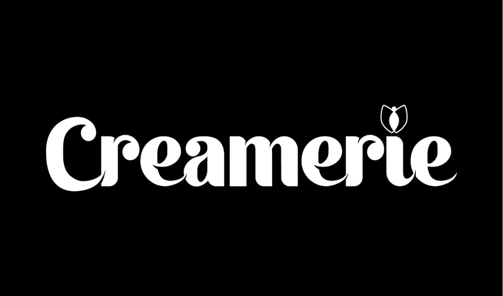 The logo of Cramerie with the word in white letters on a black background, including a stylized flower above the 'i'.