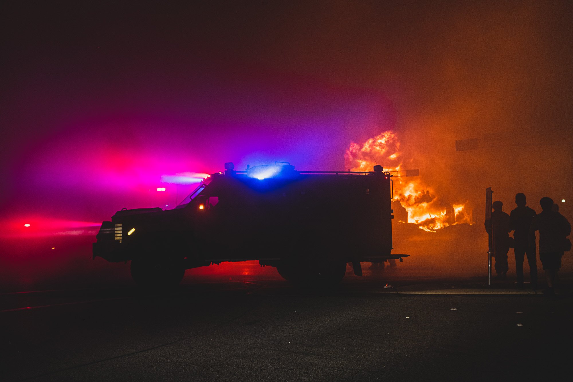 Everybody watching the town burn. Including the muscle. 