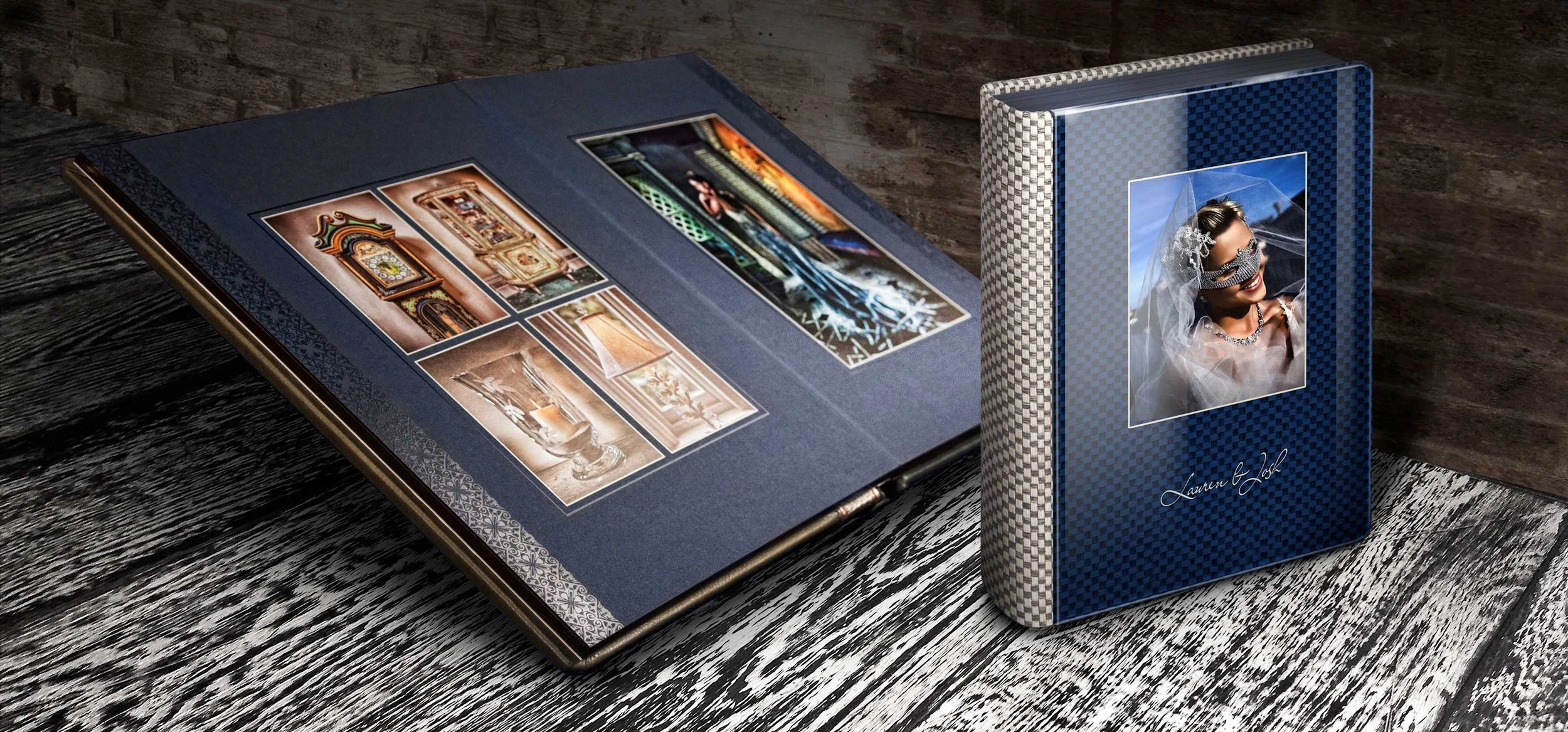 A photo album open on a wooden table, showing interior pages with various images of interior designs and artwork, beside a blue photo box with a woman's portrait on the cover, wearing sunglasses and jewelry, with the text 'Lauren & Joel'.