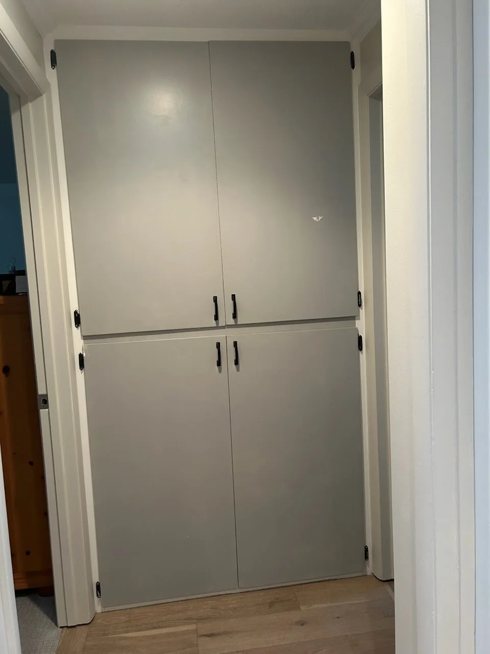 Hallway cabinetry before cabinet door replacement in Cottonwood Heights, Utah