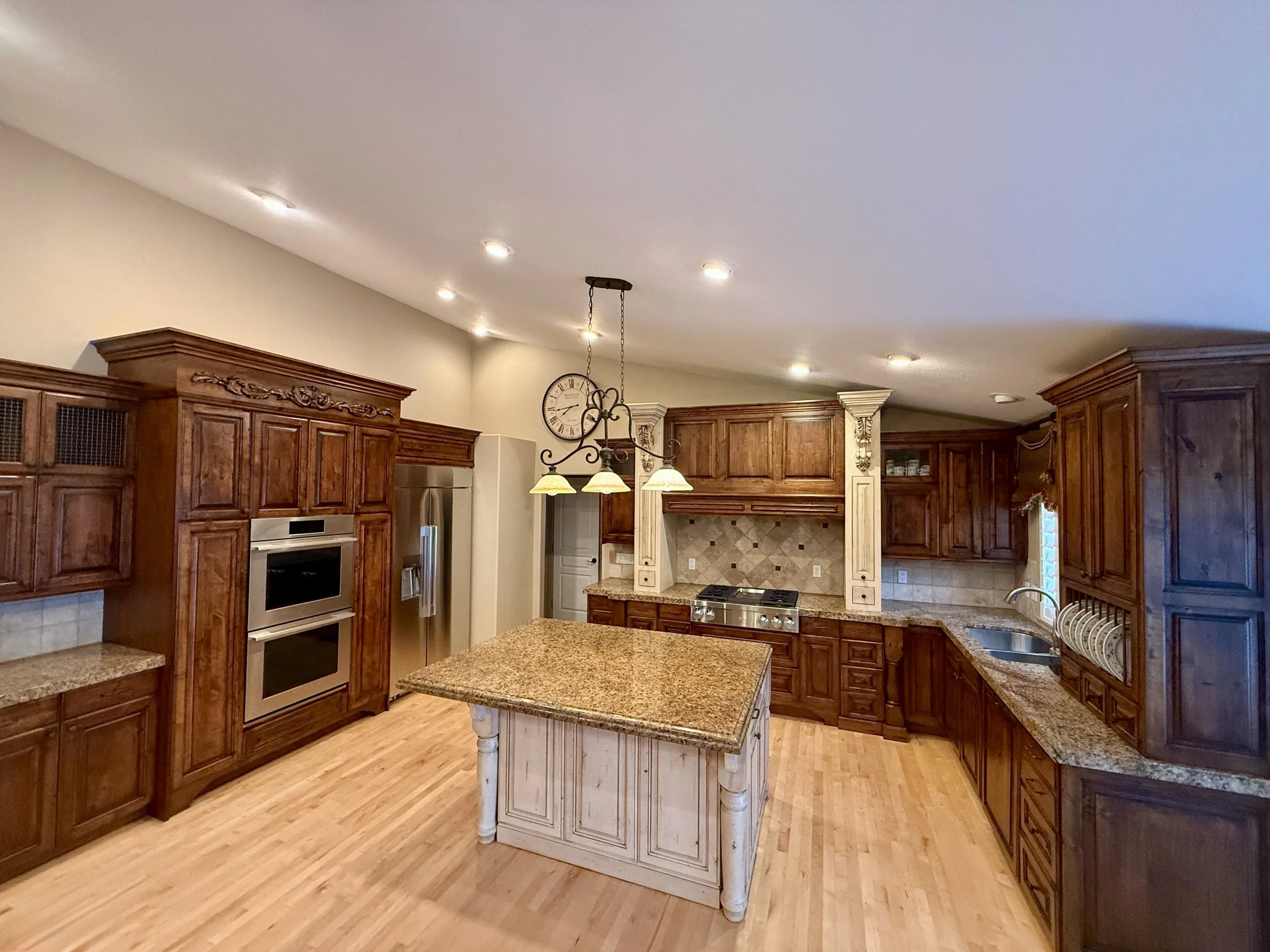 Bountiful, Utah kitchen with professionally refinished stained wood cabinets
