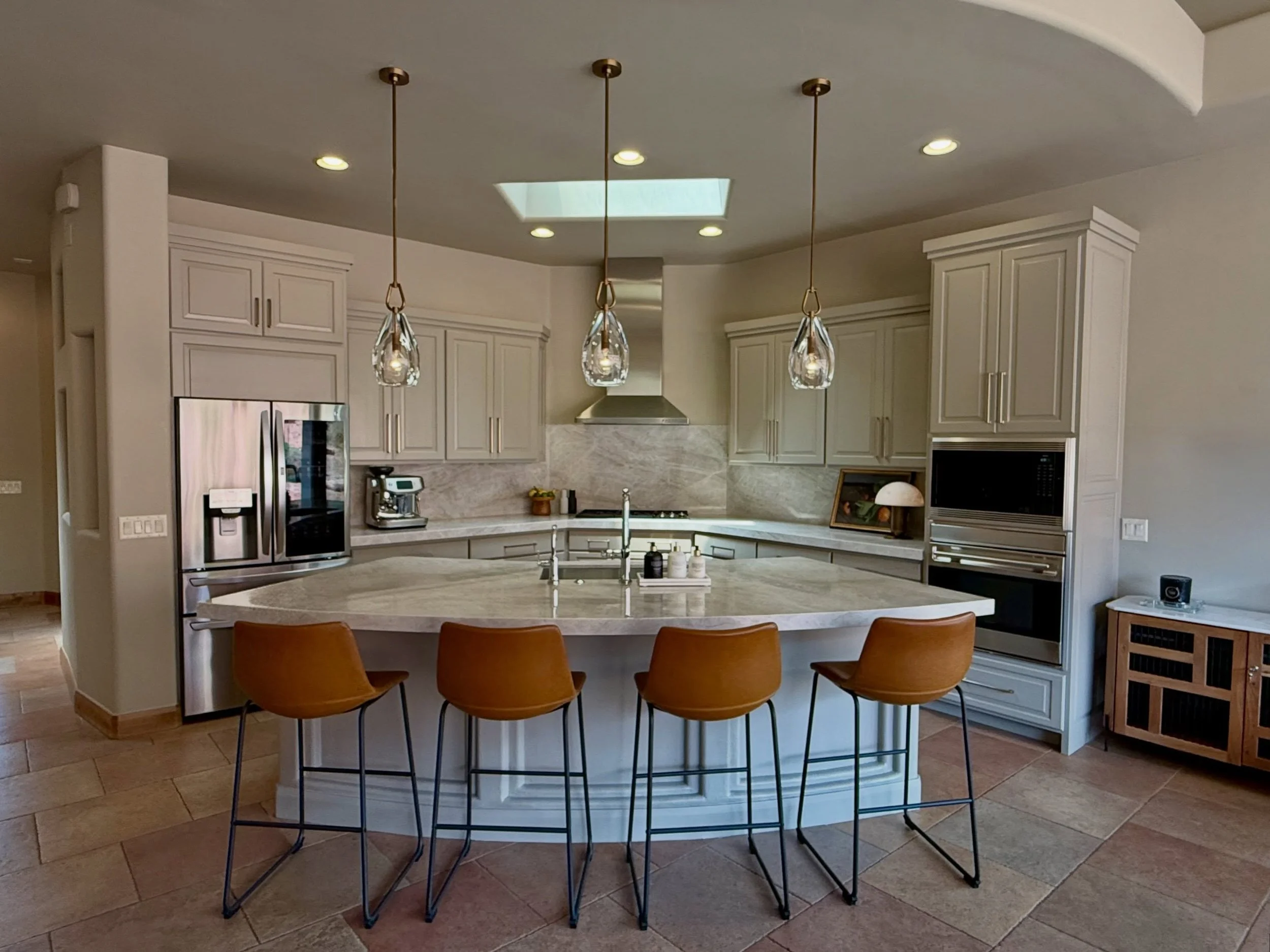 Originally, the darker cabinetry and mismatched surfaces made the kitchen feel visually heavy and disconnected.

By updating the cabinetry and creating a more cohesive relationship between the countertops and backsplash, the entire space now feels br