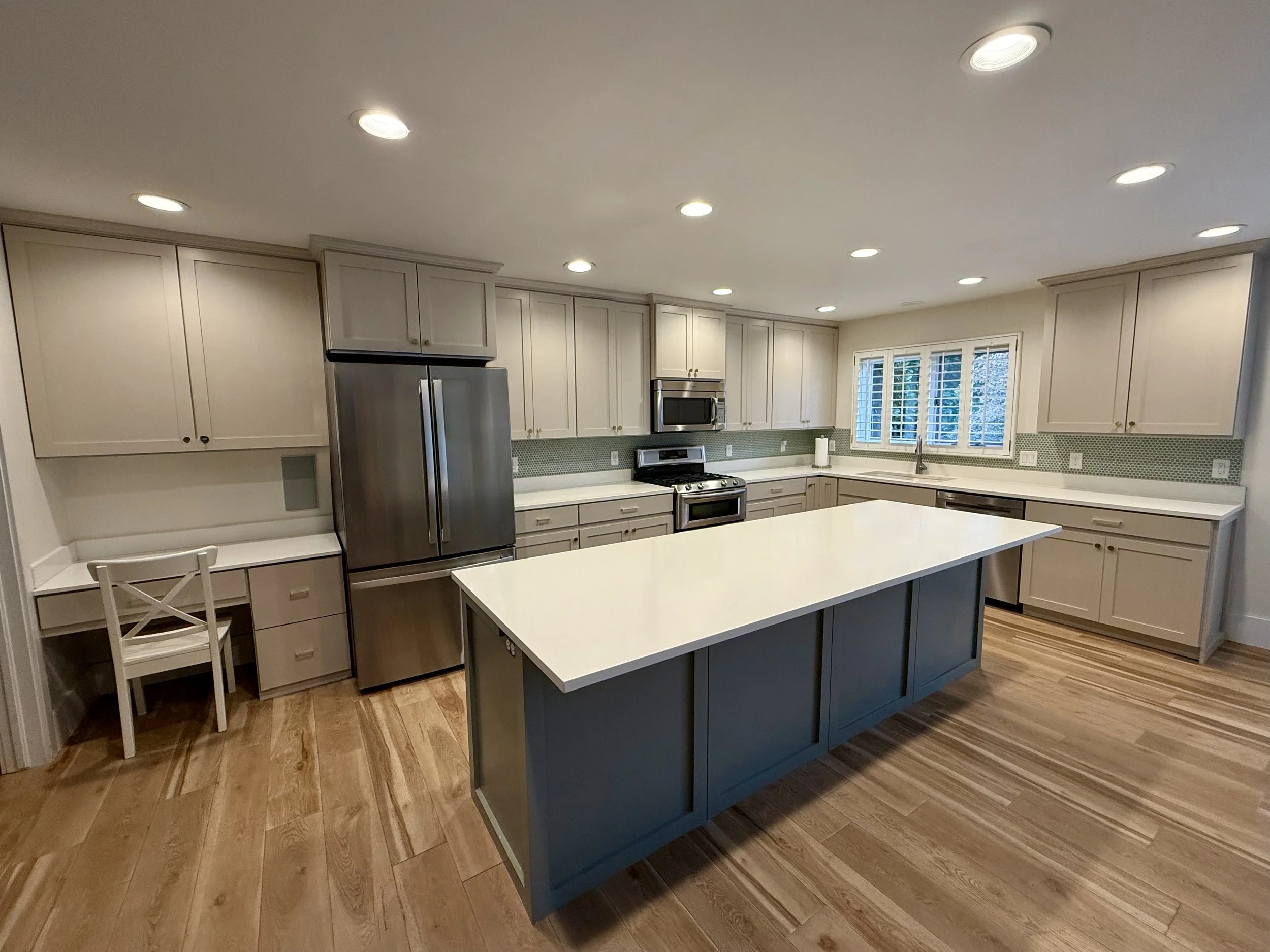 AFTER | Holladay, Utah Cabinet Refinishing & Shaker Door Upgrade: 
Kitchen transformation featuring new shaker cabinet doors and drawer fronts, updated knobs and pulls, and added architectural trim on the island and perimeter end panel. The perimeter