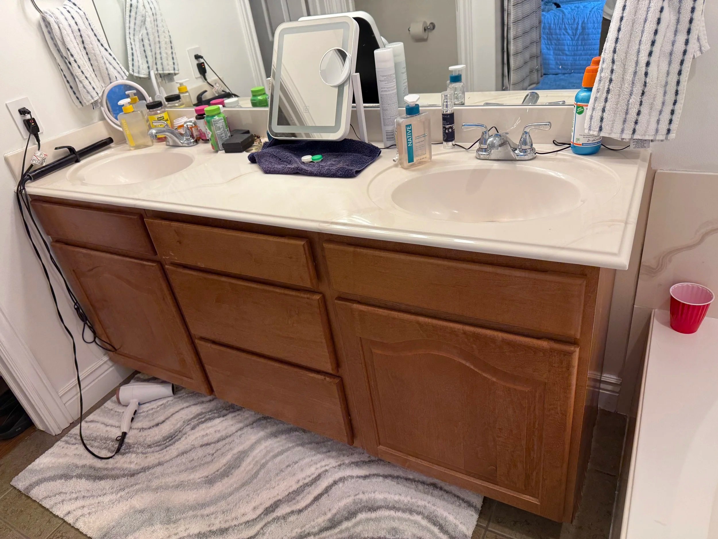 Original wood bathroom vanity in North Salt Lake before cabinet refacing and quartz countertop replacement