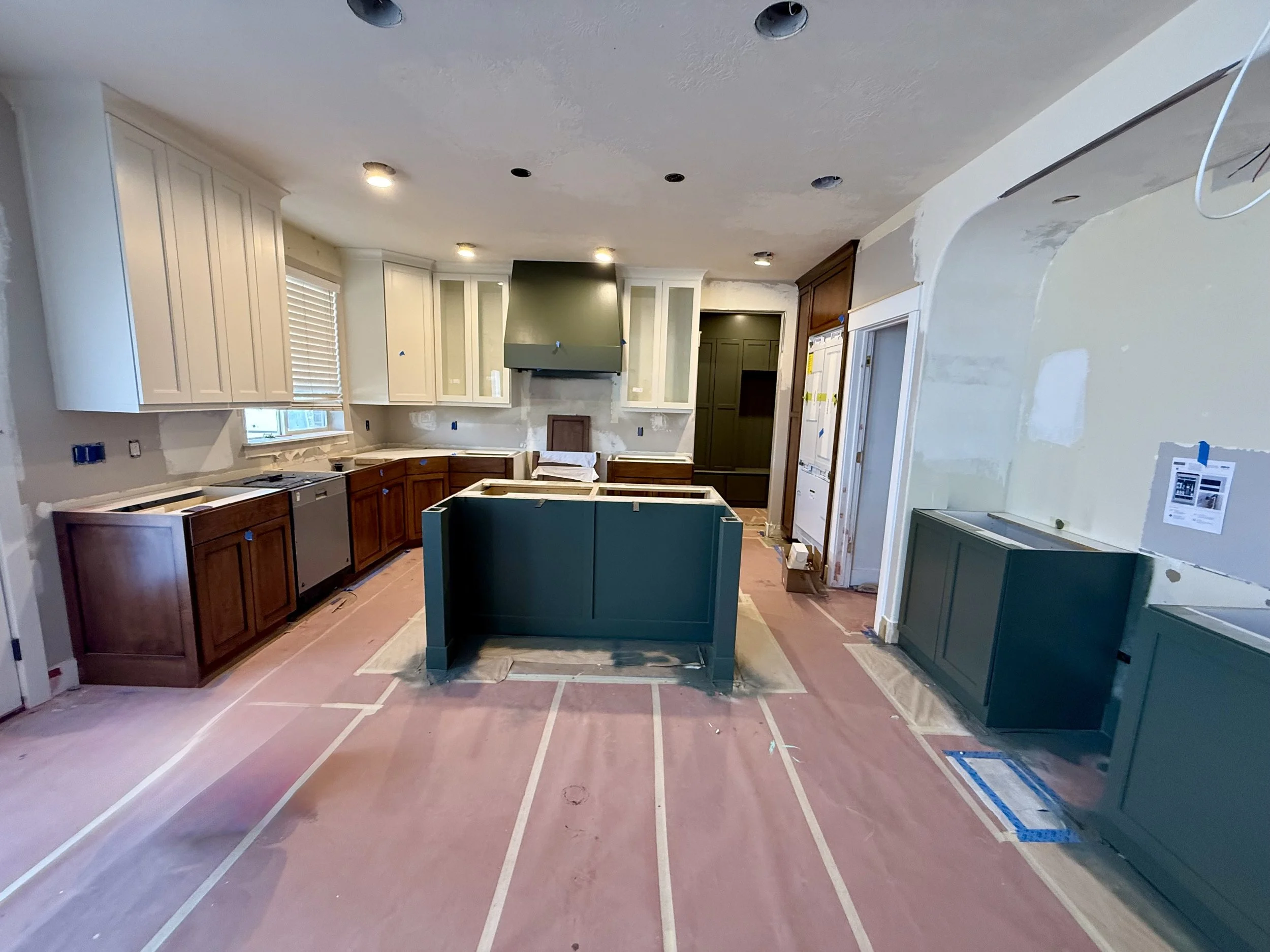 Bluffdale, Utah kitchen transformation with new cabinet doors, stained lower cabinets, painted upper cabinets, and custom vent hood