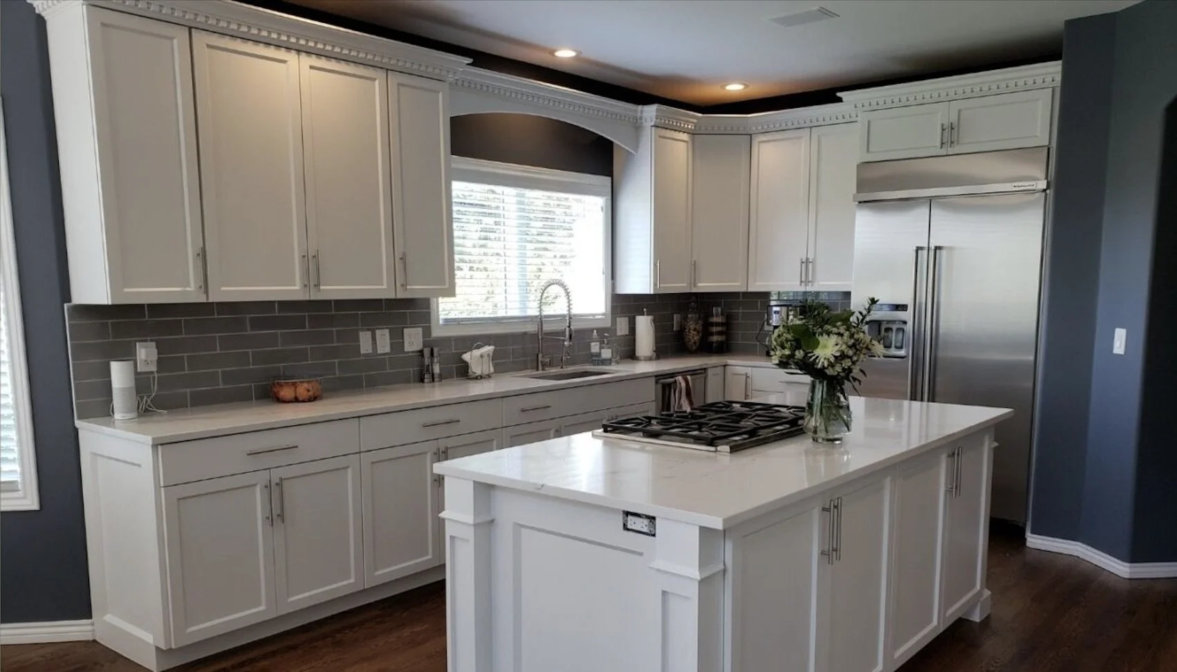Kitchen cabinet refinishing with two-tone painted cabinets and added island trim