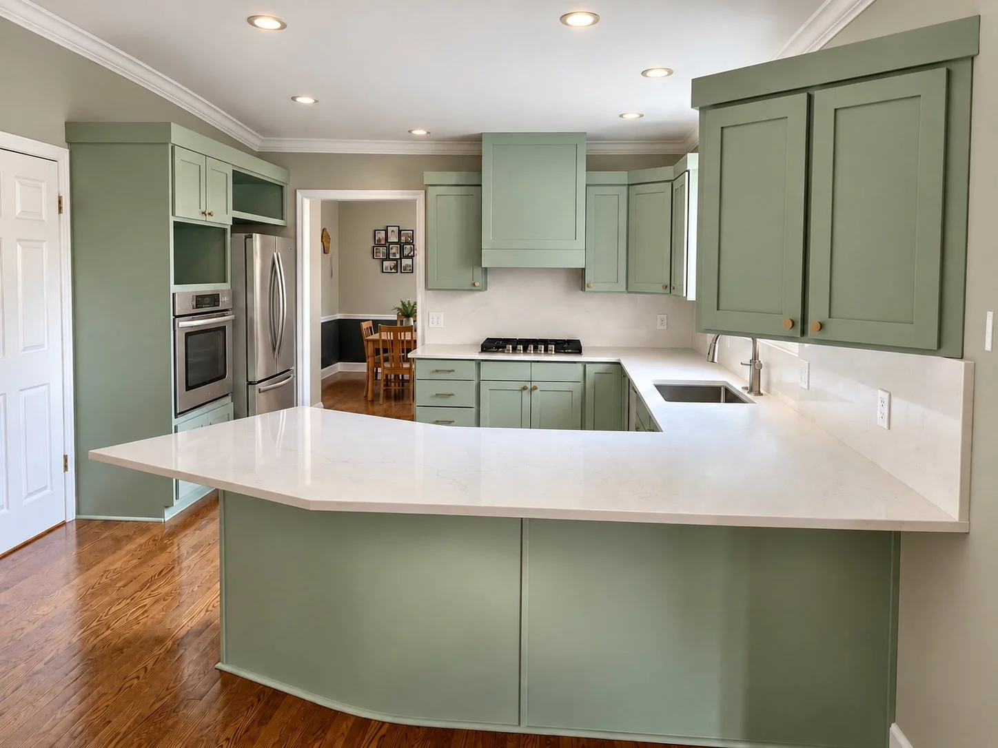 Sandy, Utah kitchen after cabinet refinishing with new shaker doors, custom vent hood, crown molding and quartz countertops with full height backsplash