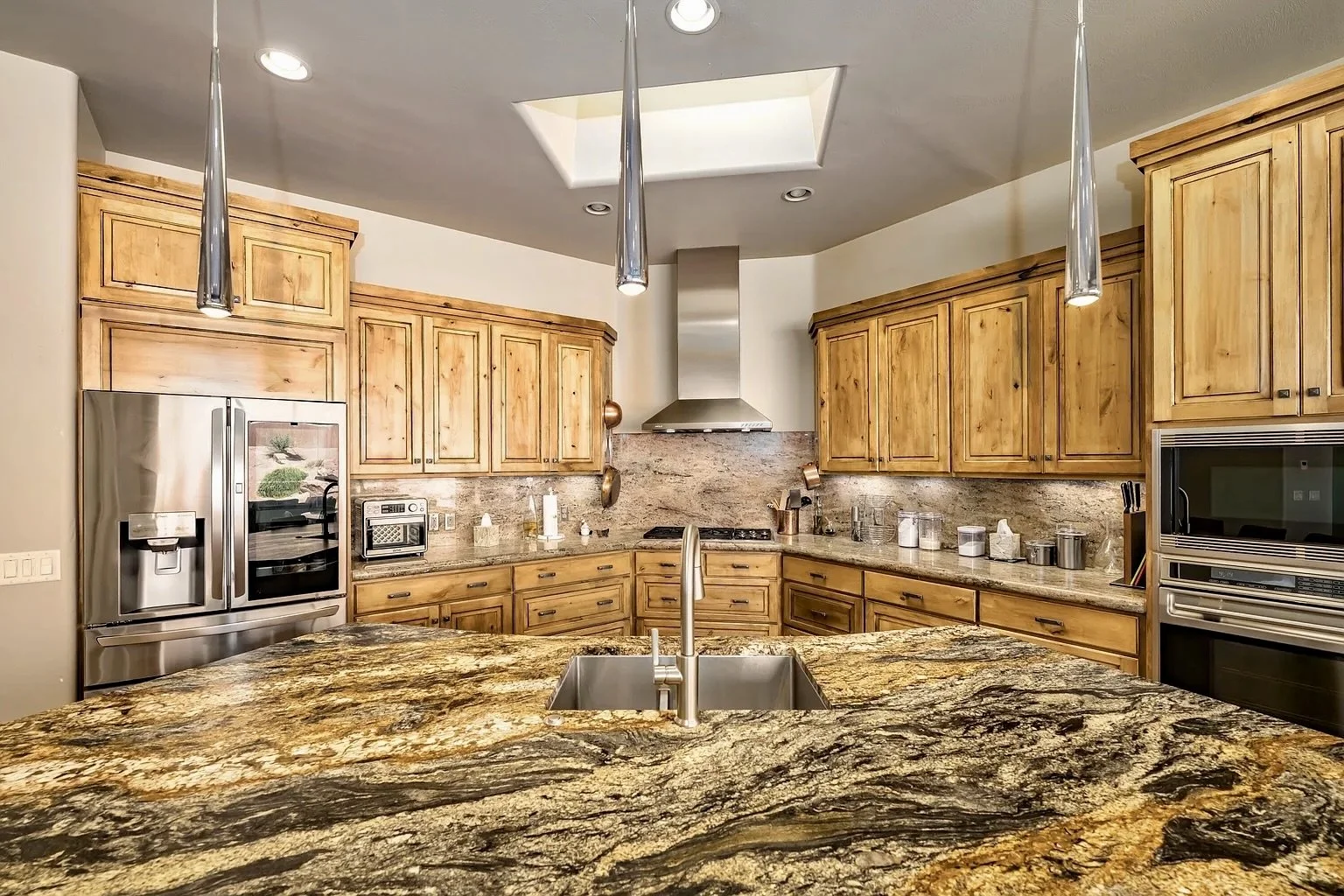 St. George Utah kitchen before cabinet refinishing with knotty wood cabinets and granite countertops