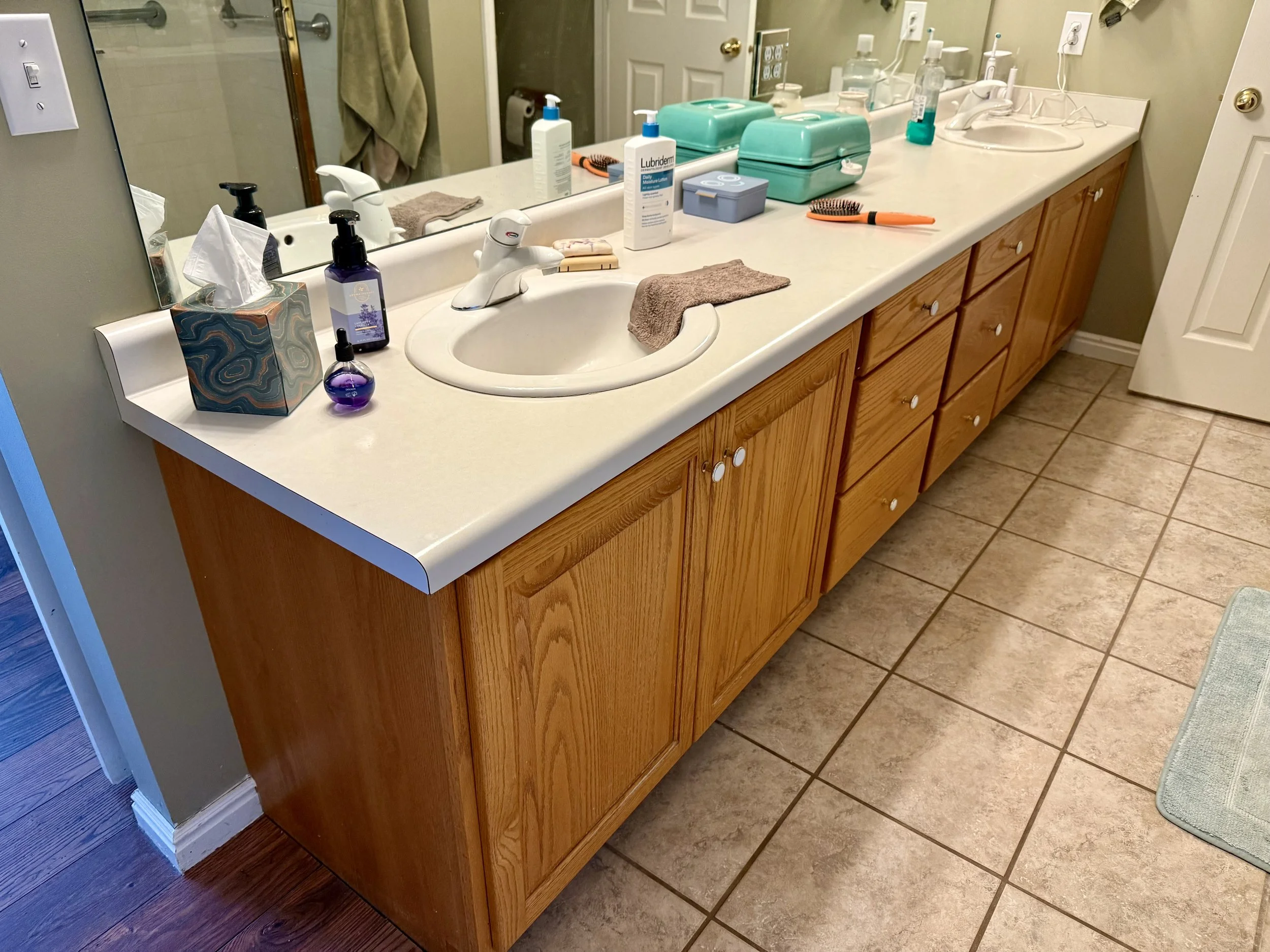 Original wood bathroom vanity in North Salt Lake before cabinet refinishing and new quartz countertops
