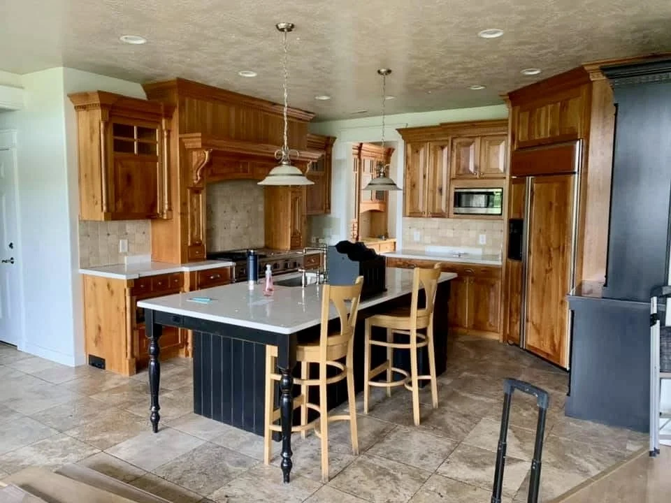 Kitchen with dated wood cabinets prior to modernization