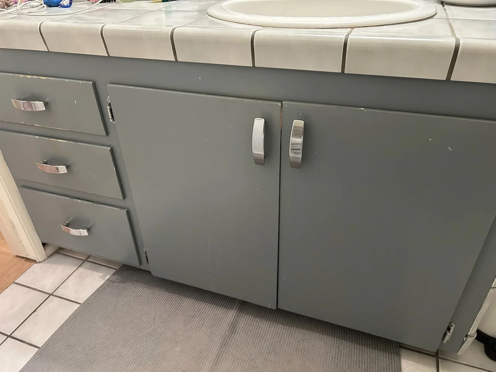 Bathroom vanity with dated flat cabinet doors before cabinet door replacement in Cottonwood Heights, Utah