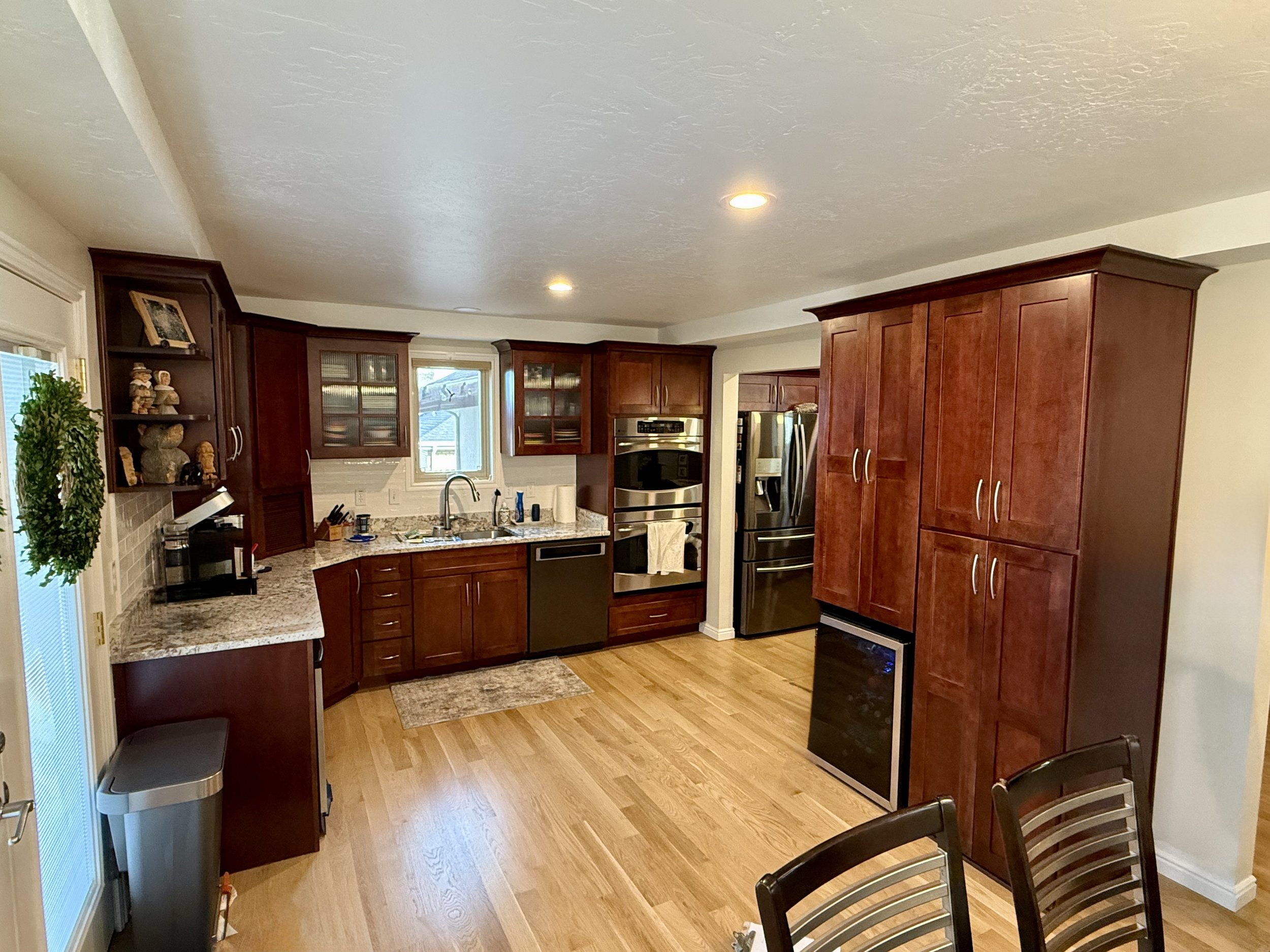 Bountiful, Utah kitchen before cabinet refinishing with dark cherry wood cabinetry
