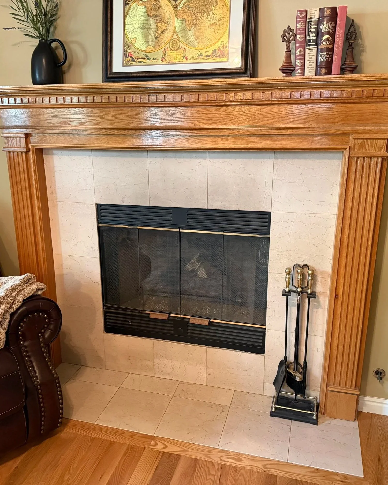 Original orange-toned wood fireplace surround in North Salt Lake before refinishing and restaining