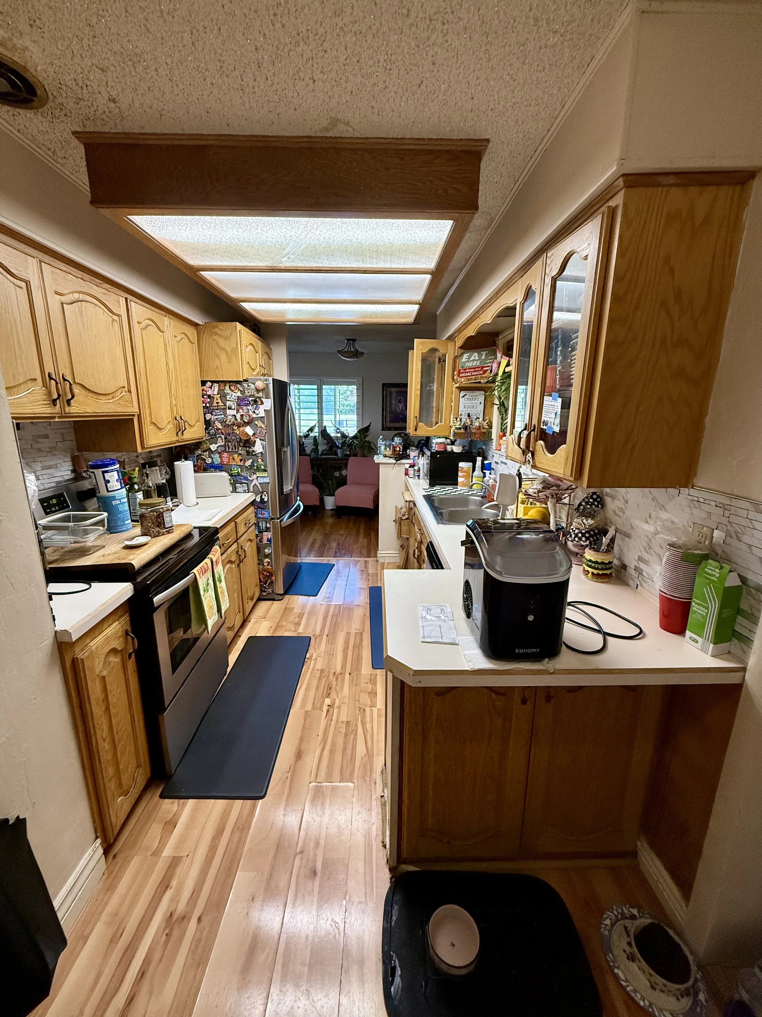 Kaysville, Utah kitchen before cabinet refinishing with original wood cabinets and outdated countertops