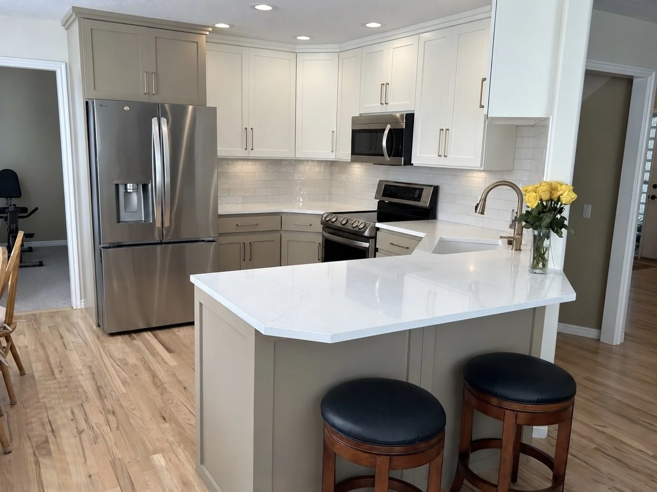 

AFTER | Cottonwood Heights Cabinet Refinishing & Refacing: CAZI Refined Finishes transformed this kitchen by professionally refinishing the existing cabinetry, installing new Shaker-style cabinet doors and flat drawer fronts, and adding decorative 