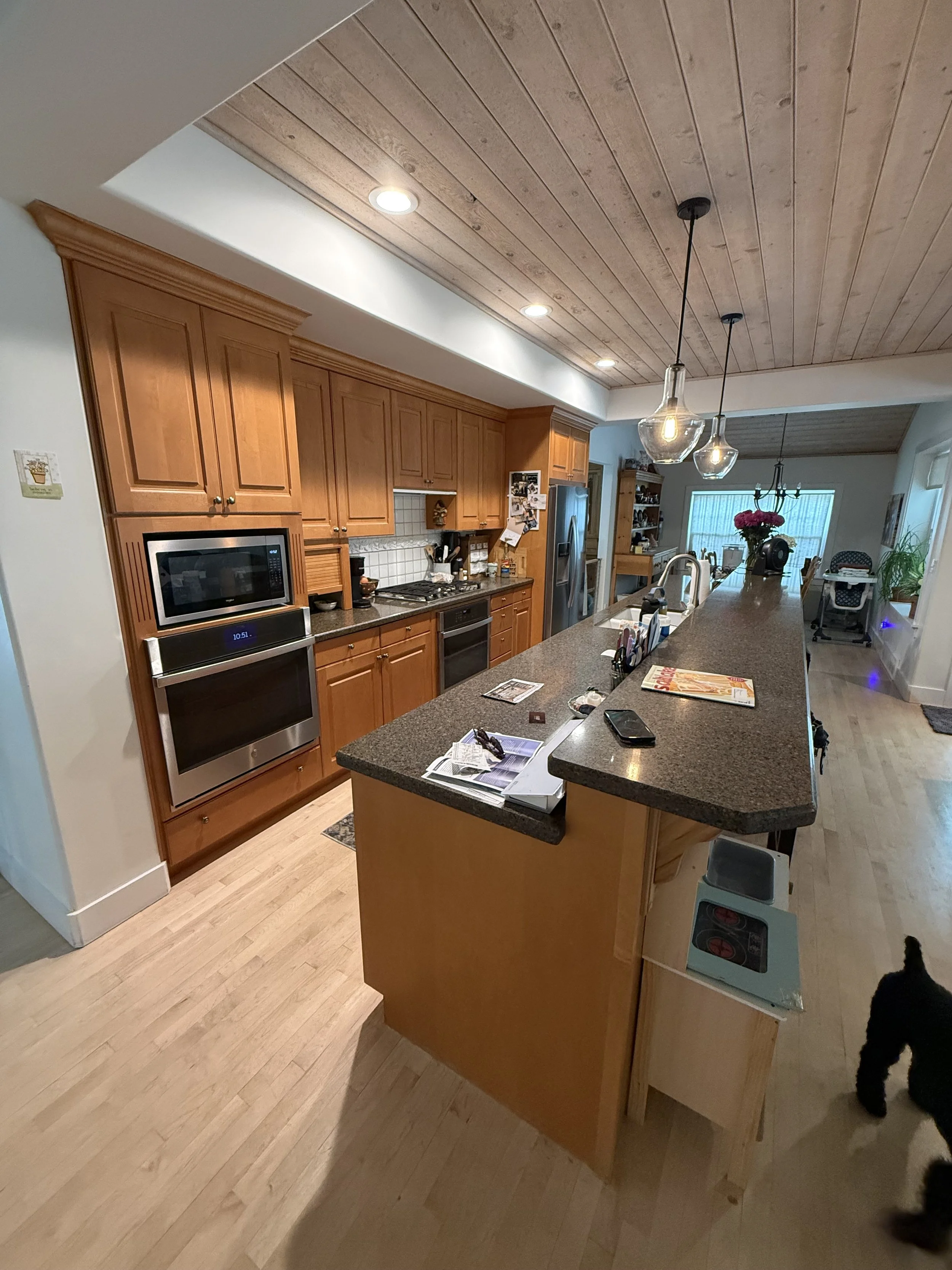 Orange oak kitchen before cabinet refinishing in Cottonwood Heights, Utah