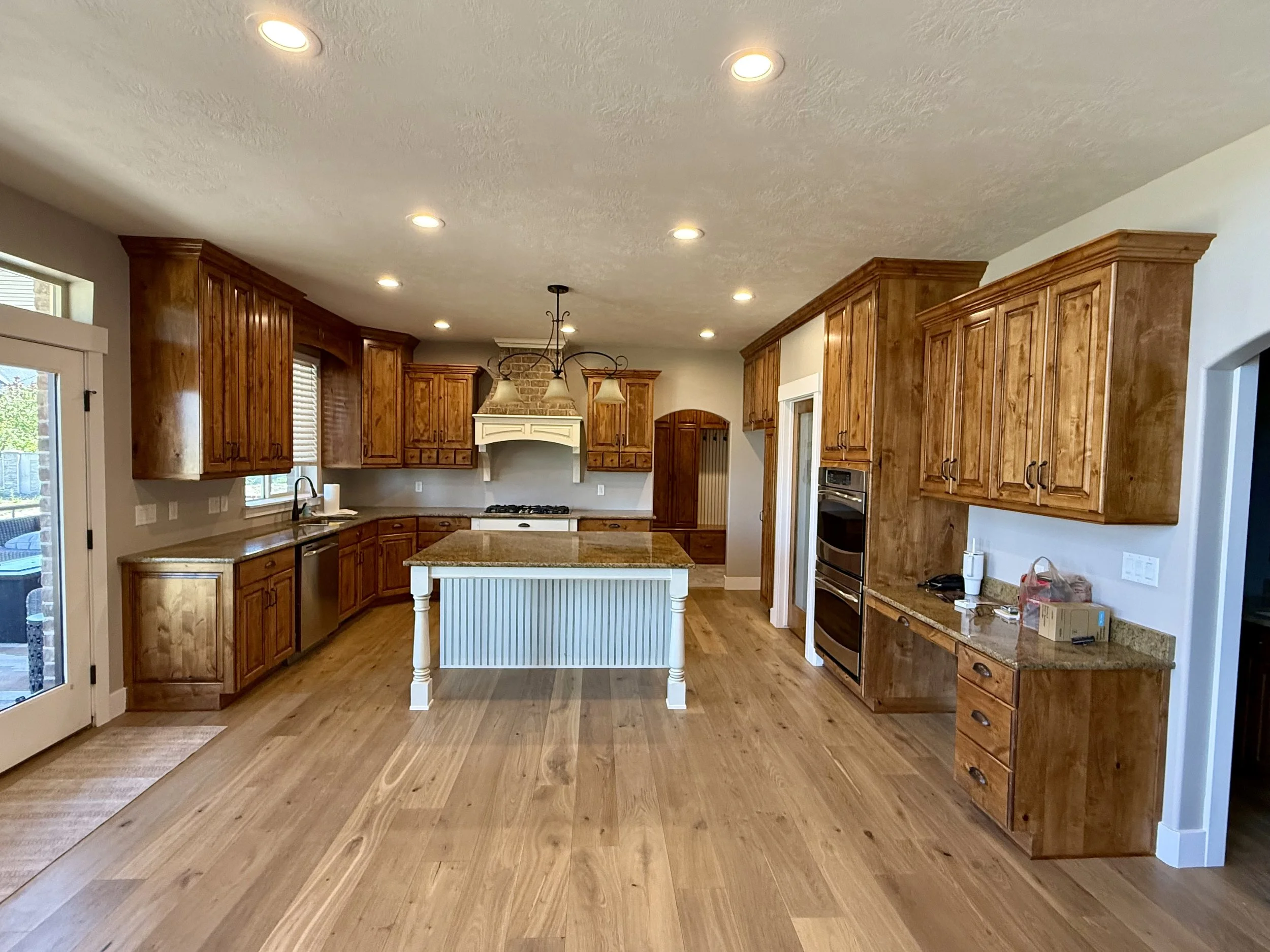Bluffdale, Utah kitchen before cabinet refinishing with traditional stained wood cabinets and raised panel doors